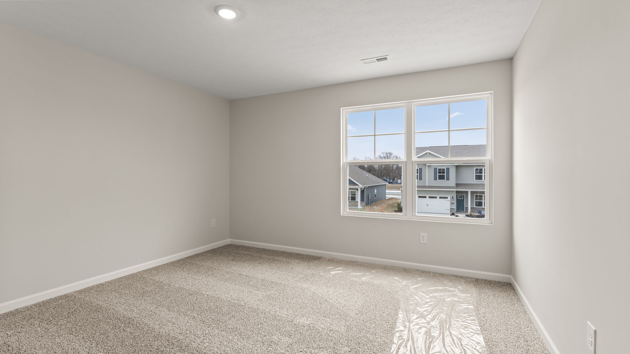 Carpeted bedroom with window