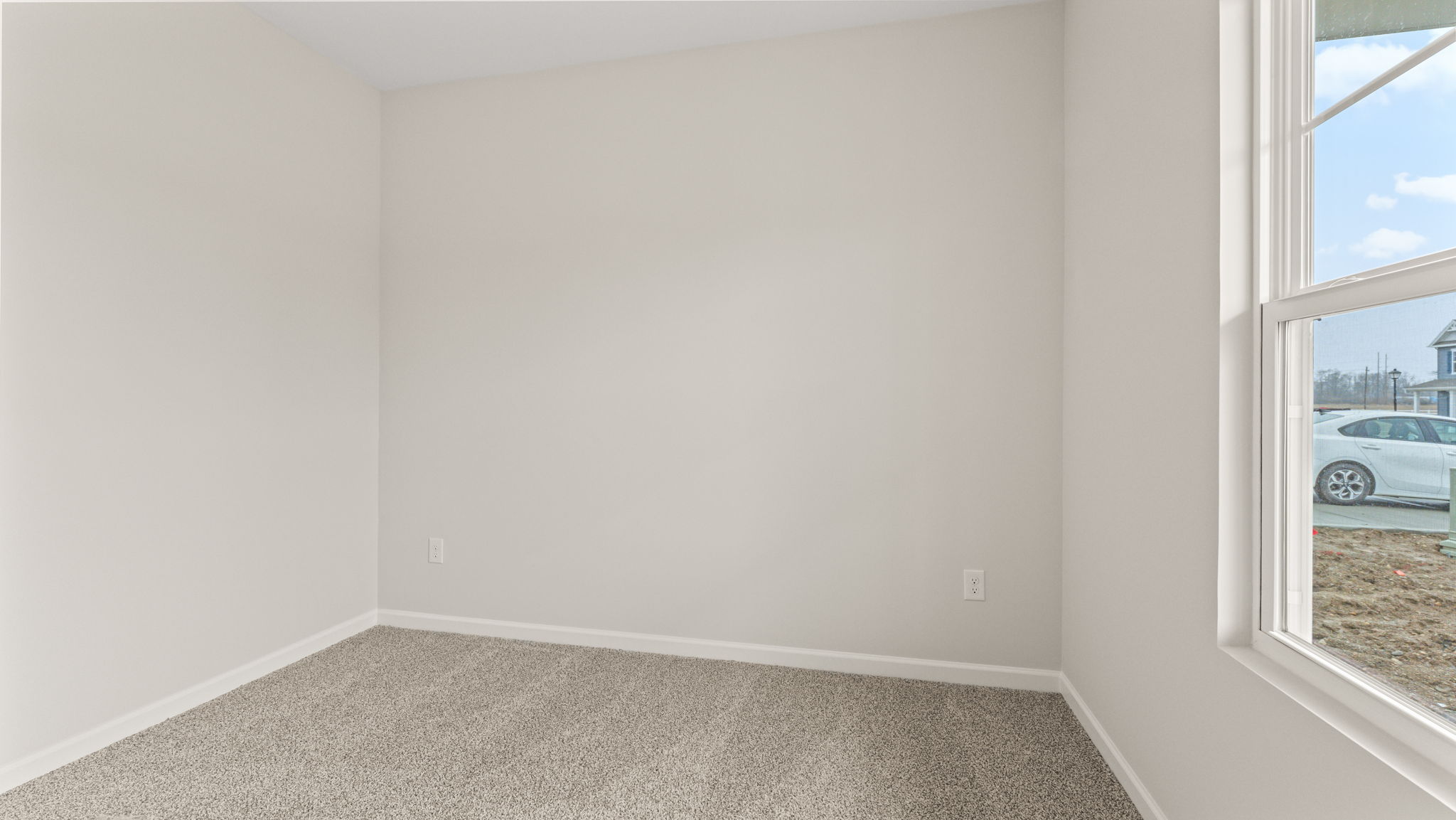 Carpeted bedroom with window