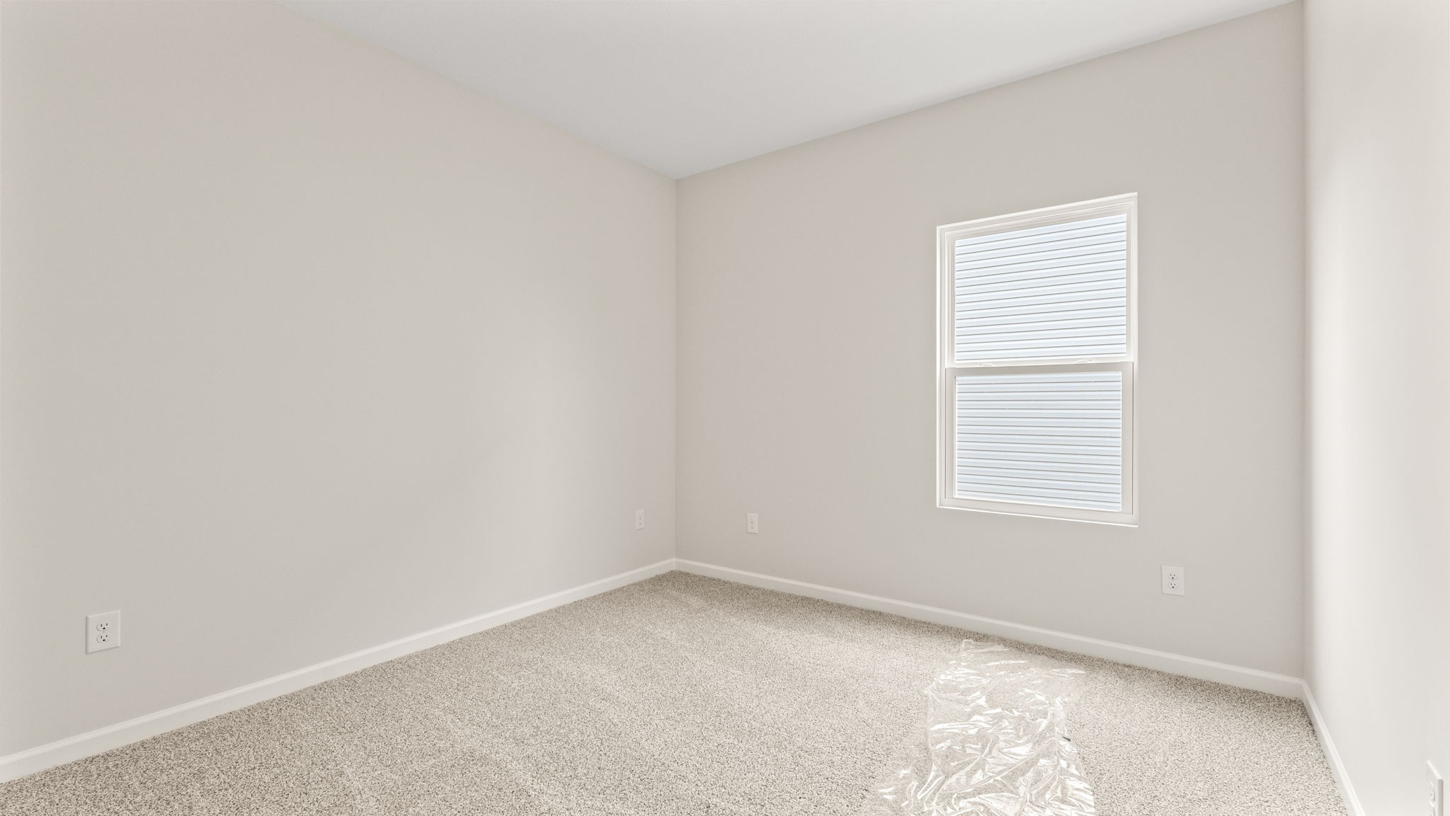 Carpeted bedroom with window