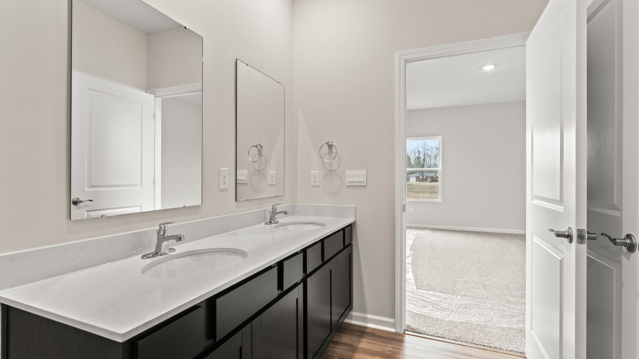 closeup of double bowl vanity with two mirrors