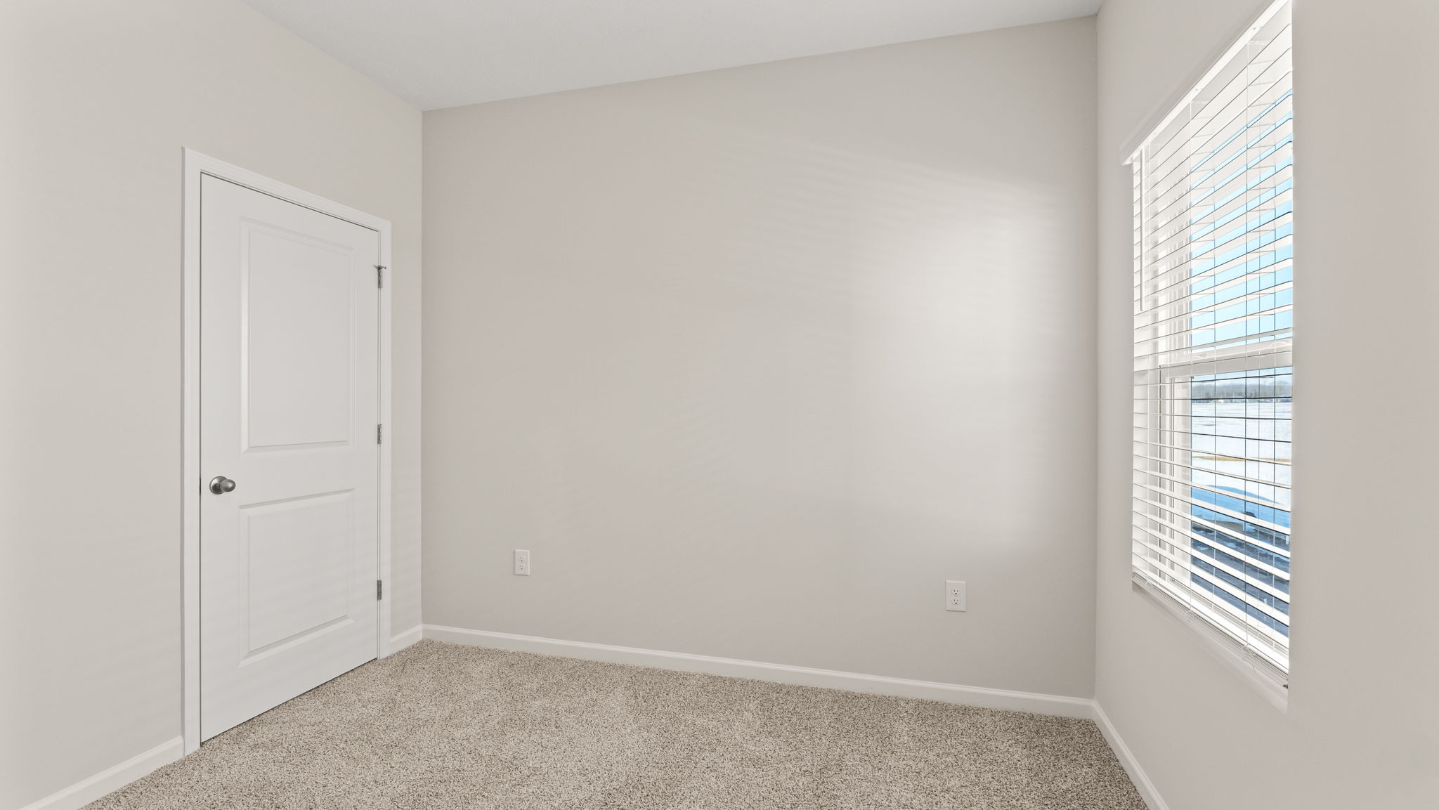 Carpeted bedroom with window