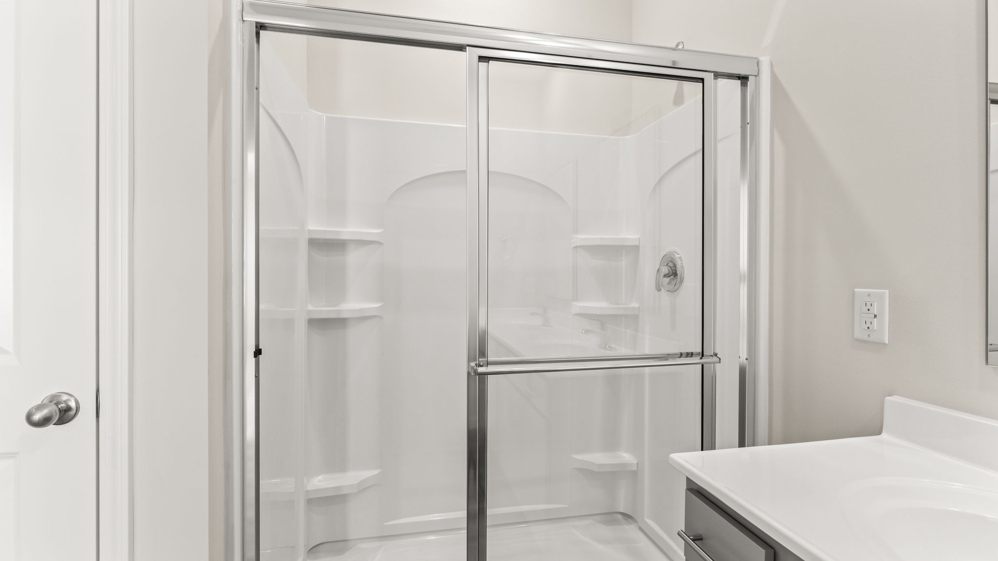 Closeup of walk-in shower with tiered shelving