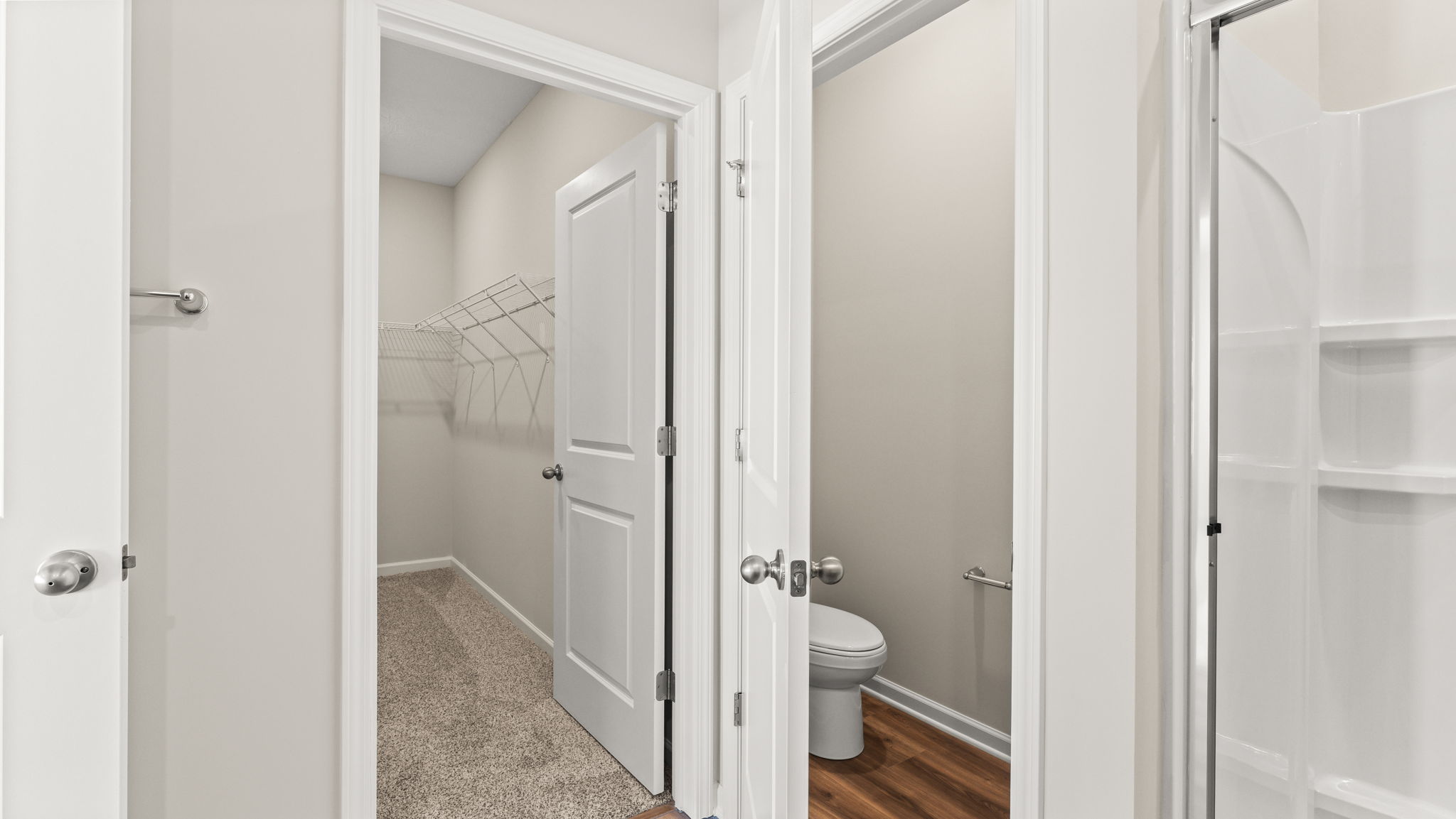 Wide view of storage and toilet areas of the primary bathroom