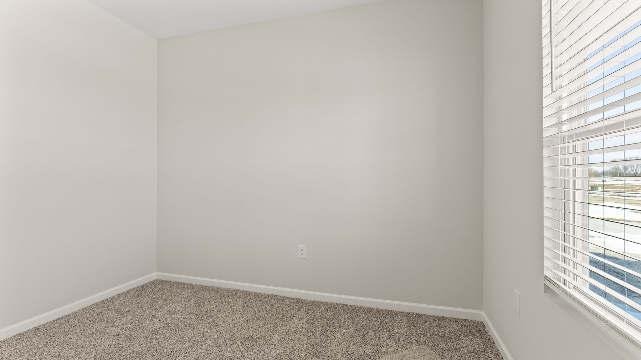 Carpeted bedroom with window