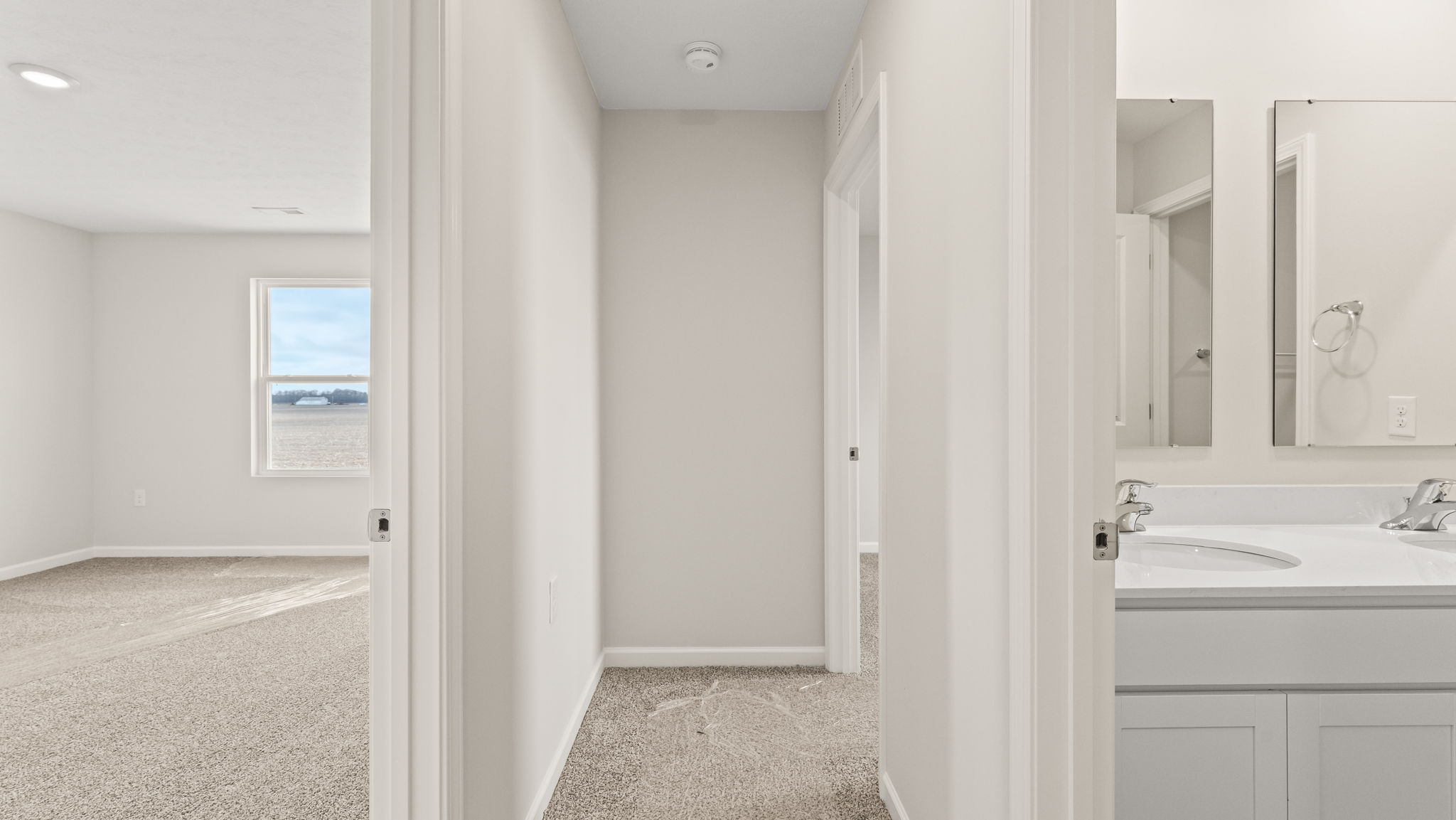 Upstairs hallway looking into bedroom on left and bathroom on right