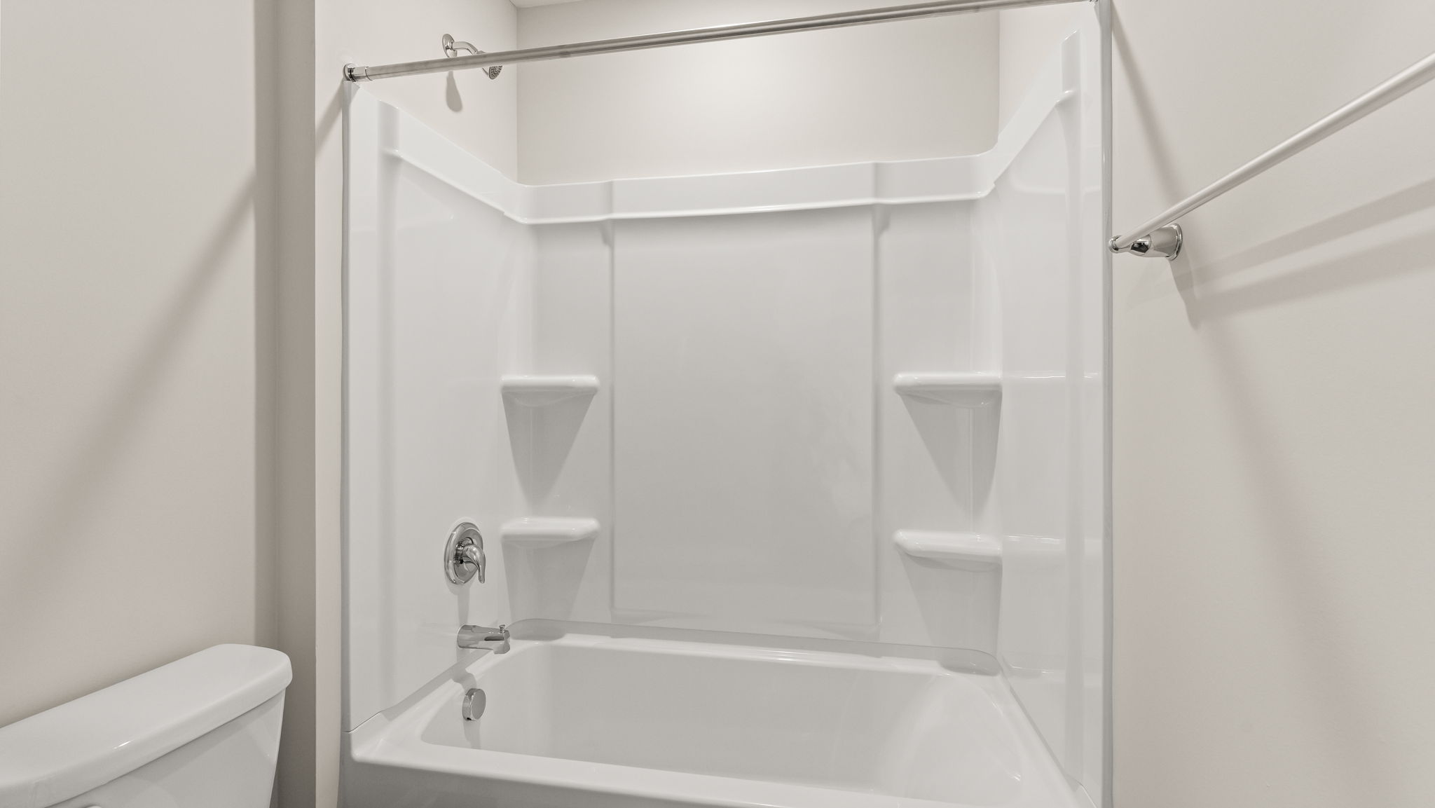 Closeup of shower and tub with tiered shelving.