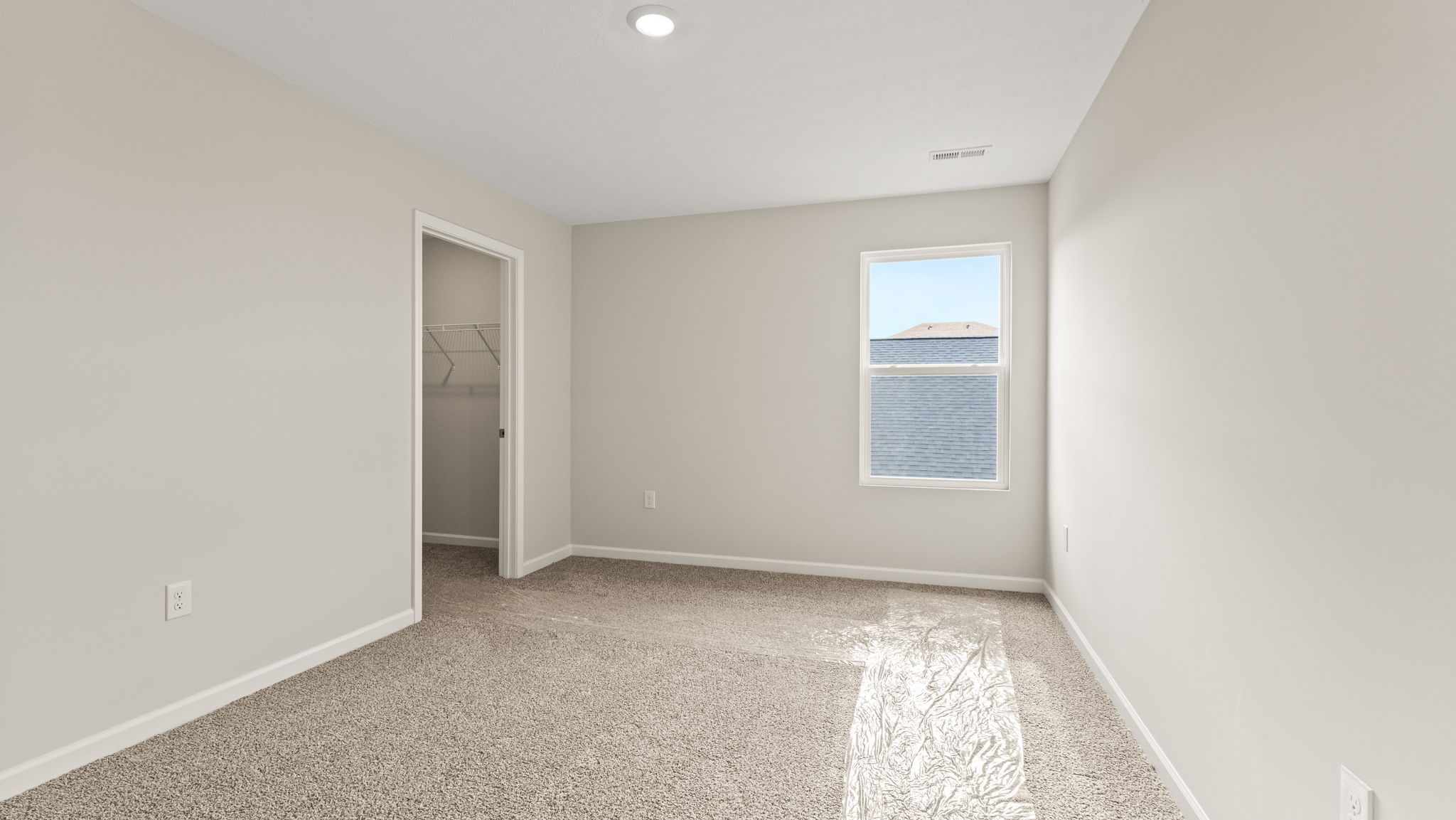 Bedroom with carpet and closet.