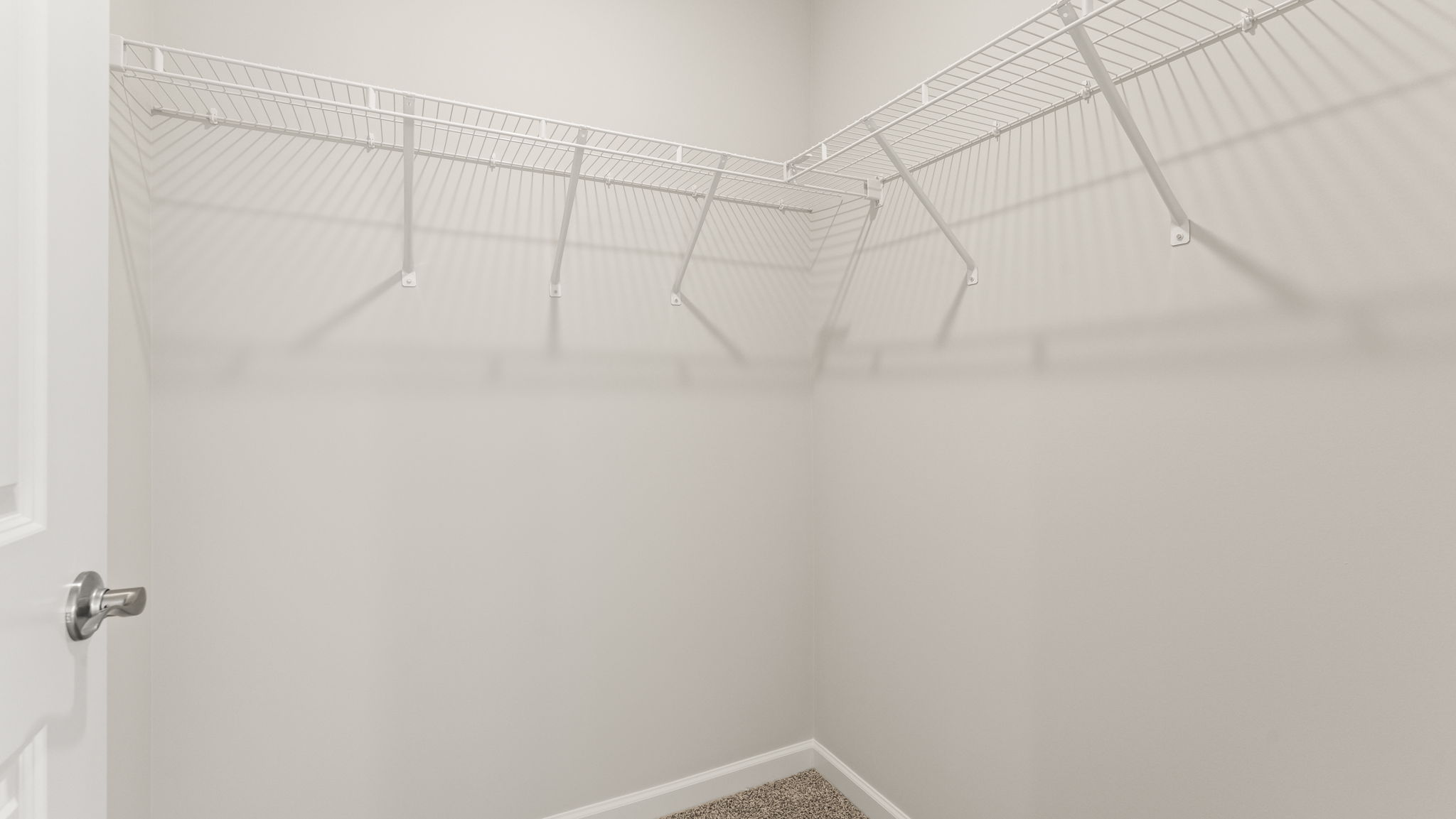 Walk-in closet with wire shelving.