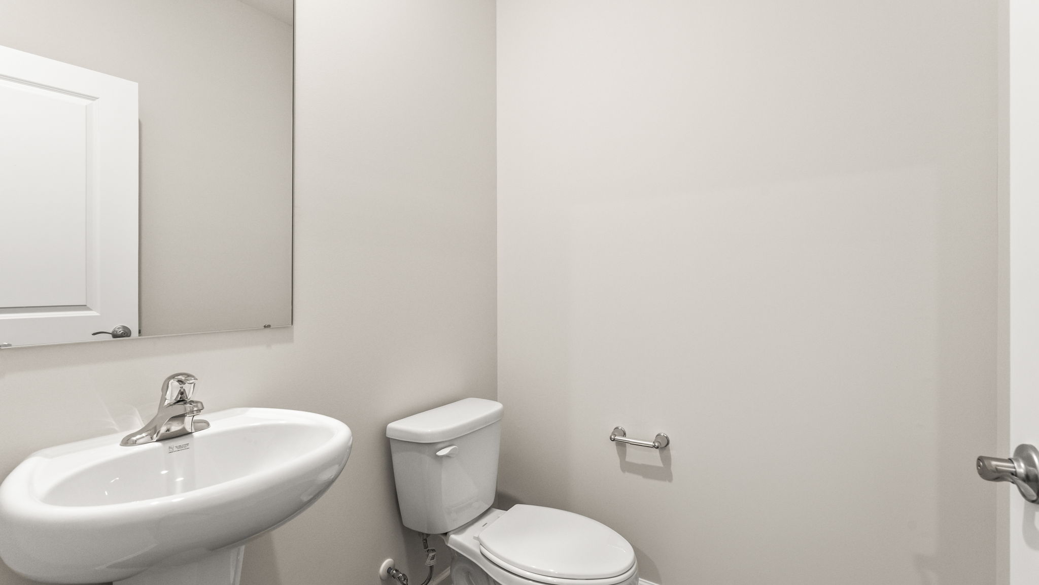 Bathroom with sink, mirror, and toilet.