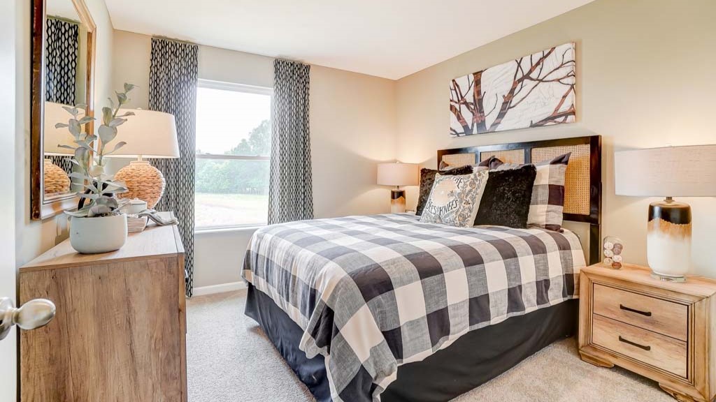 Bedroom with outdoorsy theme with large bed and wooden furniture.
