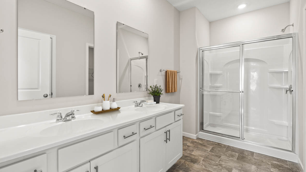 Primary Bathroom with dual vanity sinks and shower.