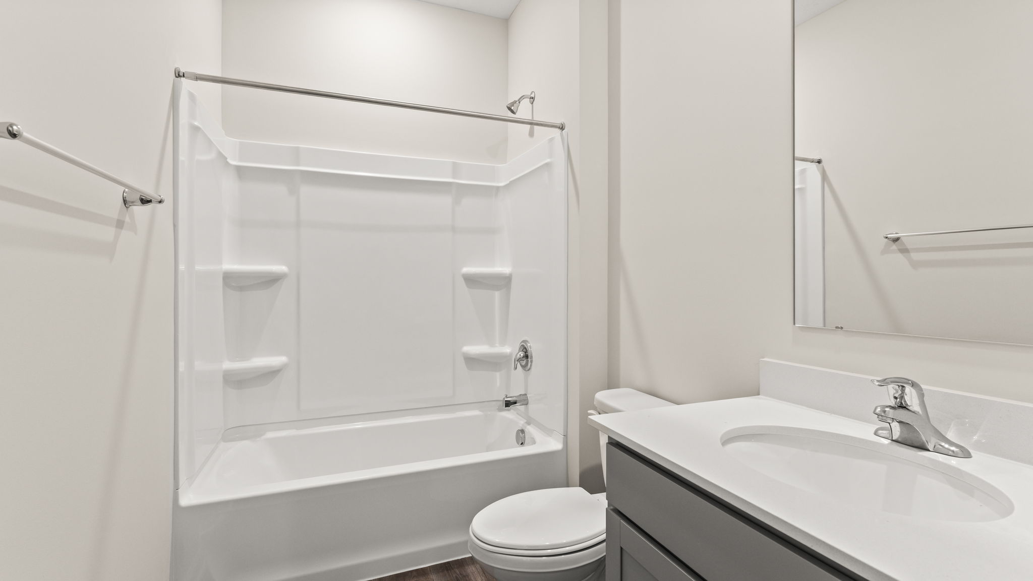 Bathroom with tub/shower, toilet, and sink.