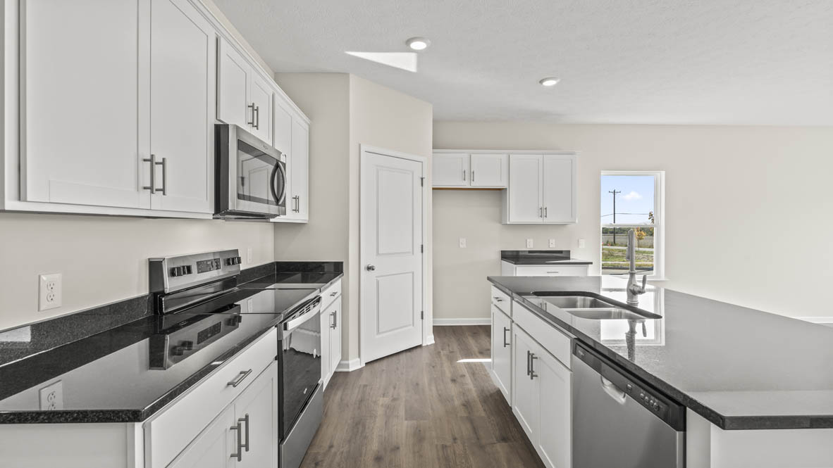 Side view of the kitchen with countertops and island on the left.