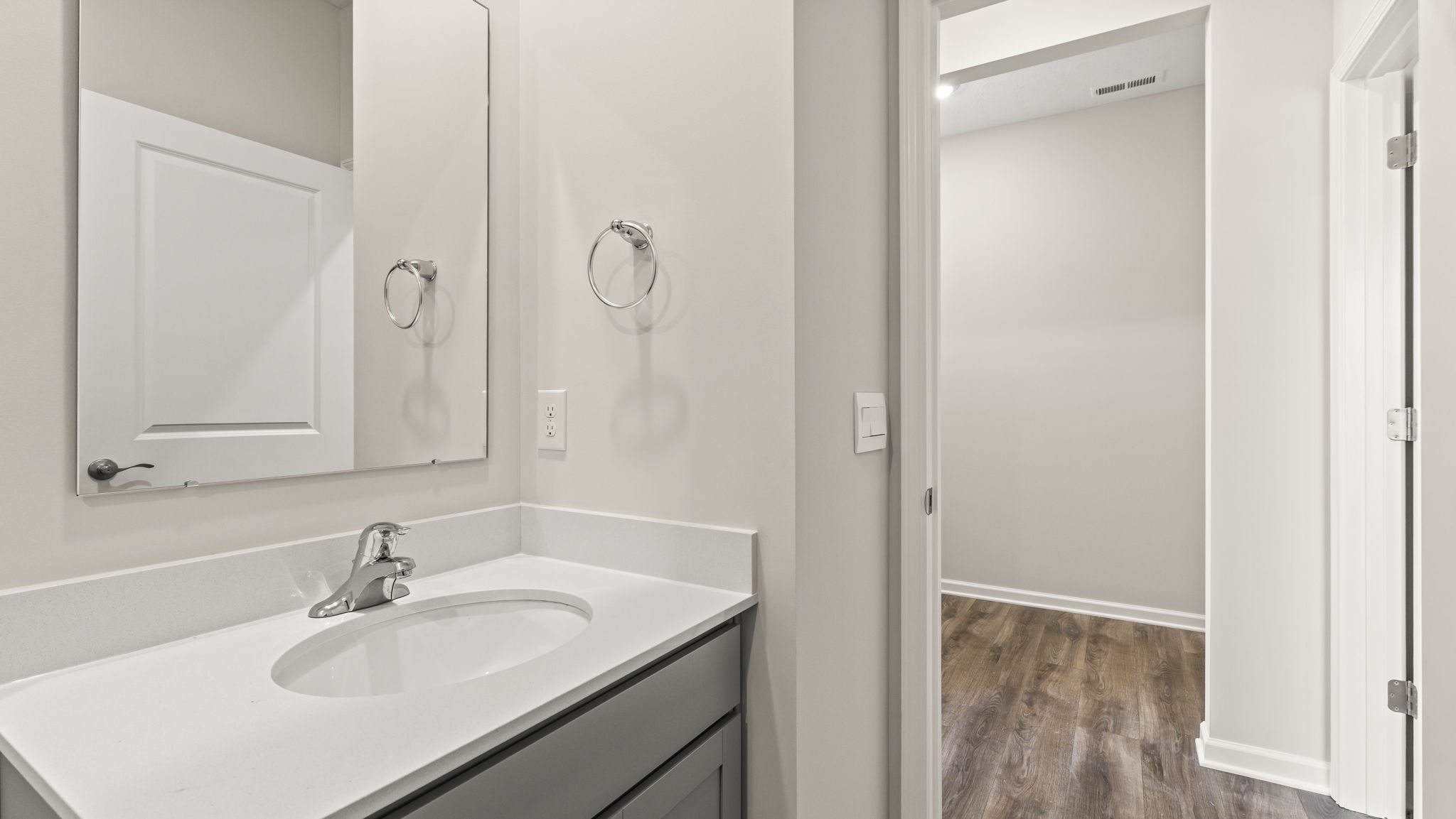 Closeup of bathroom sink and mirror.