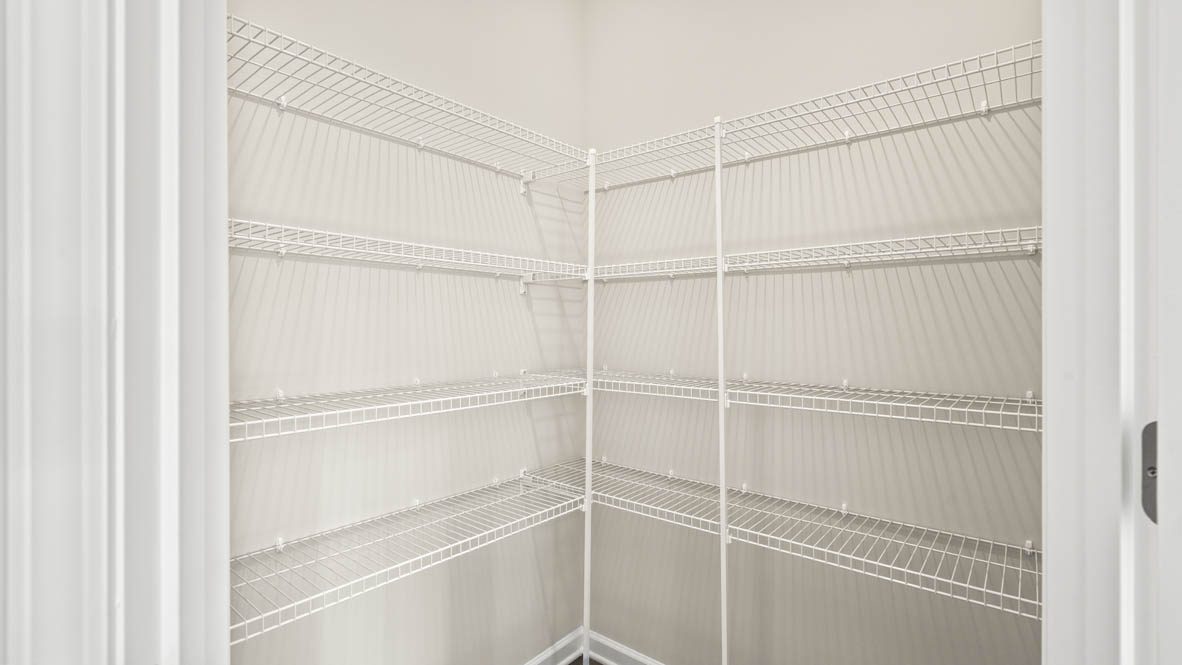 Walk-in pantry with shelving.