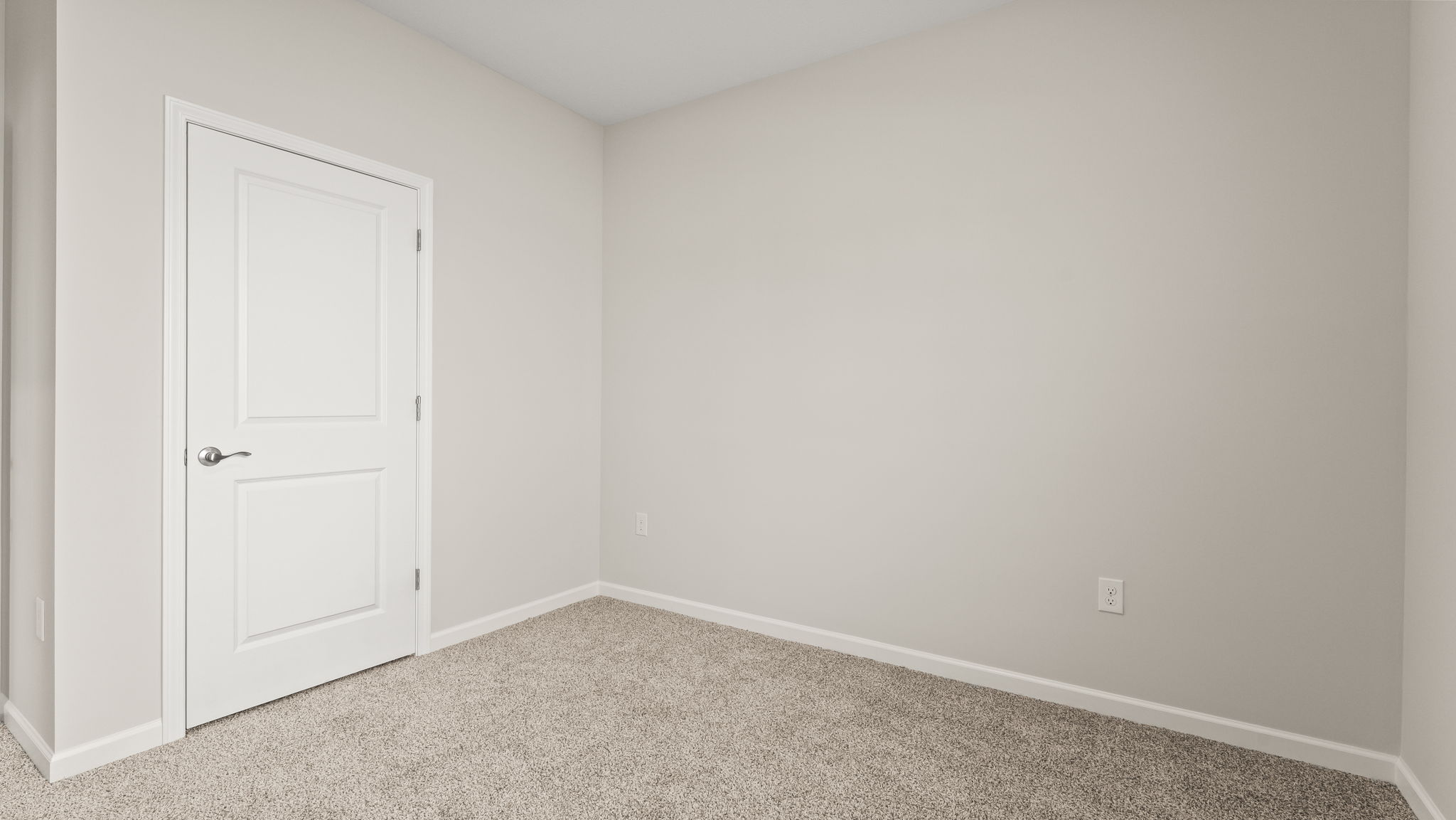 Carpeted bedroom with closet.