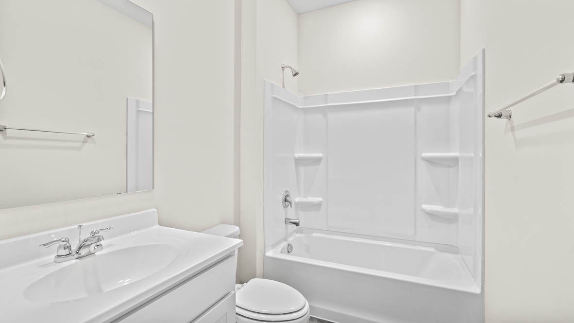 Bathroom sink, mirror, and shower.