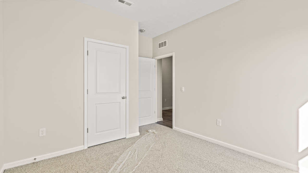 Bedroom from the window perspective with closet door and hallway in frame