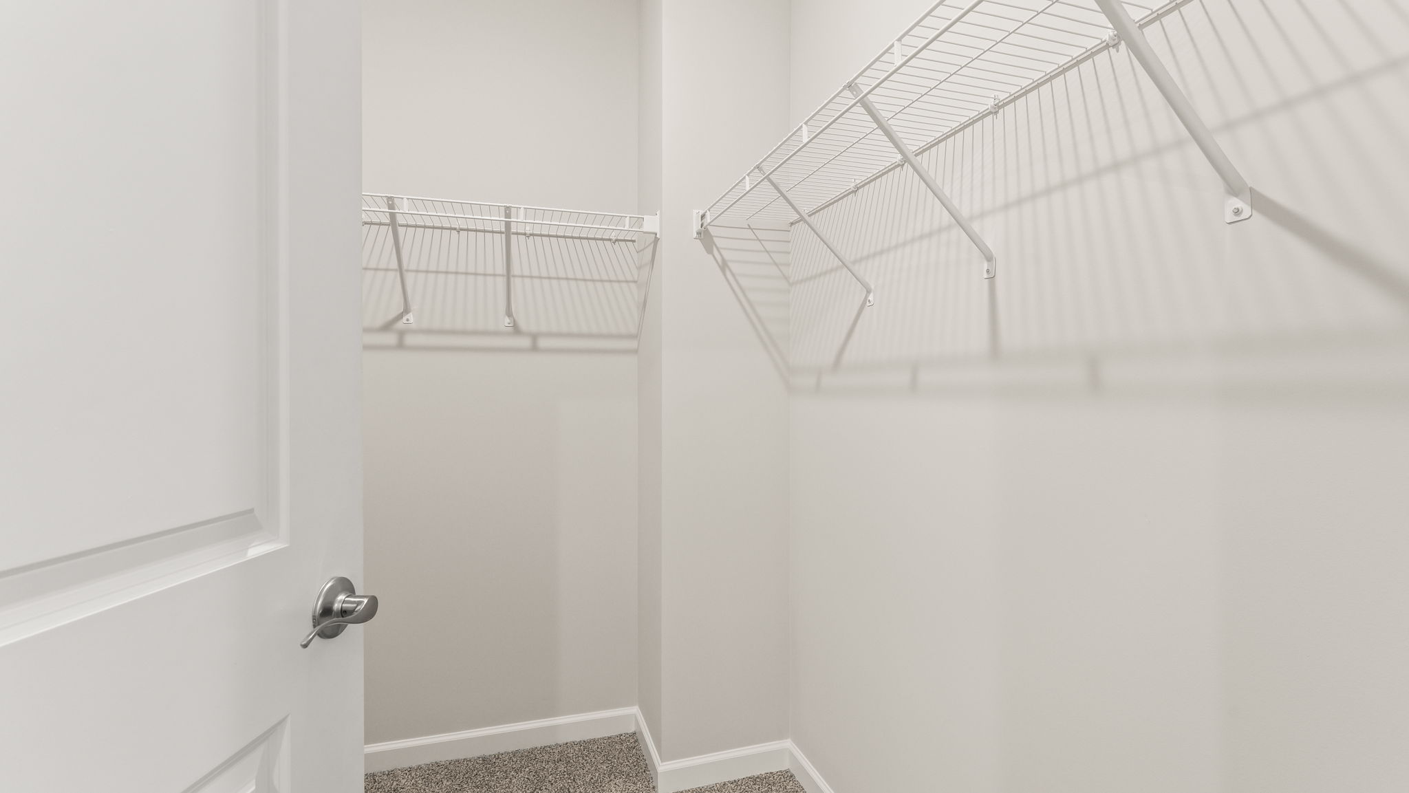 Walk-in closet with wire shelving.