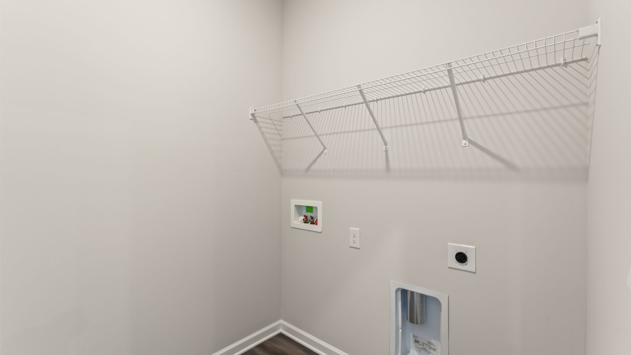 Laundry area with washer/dryer inlets.