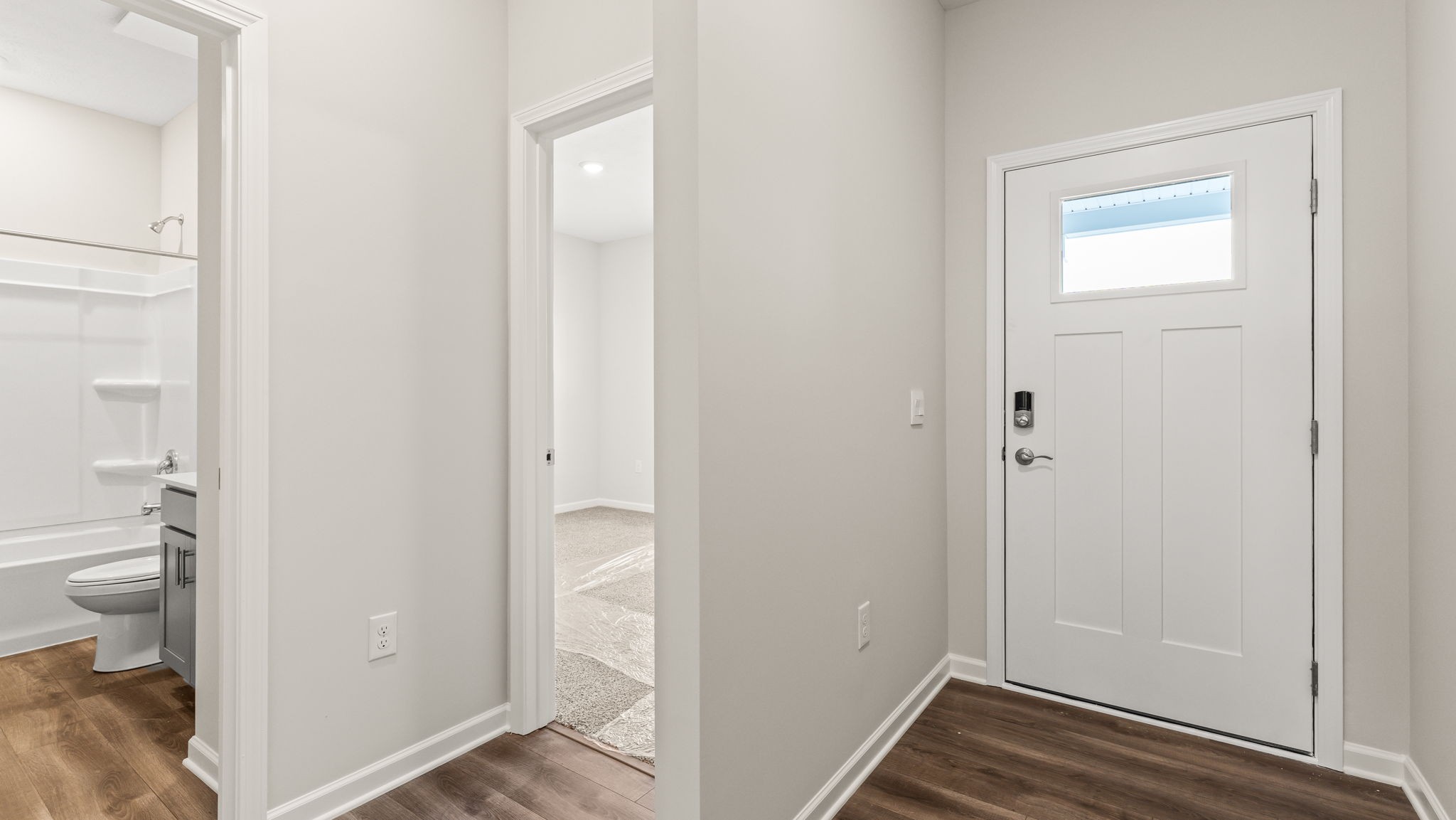 Front of the house foyer with view of bathroom and bedroom.