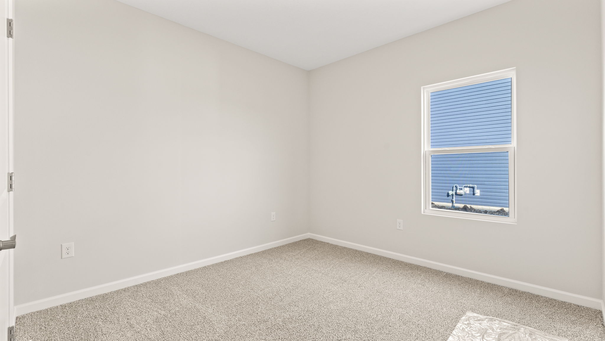 Carpeted bedroom with window