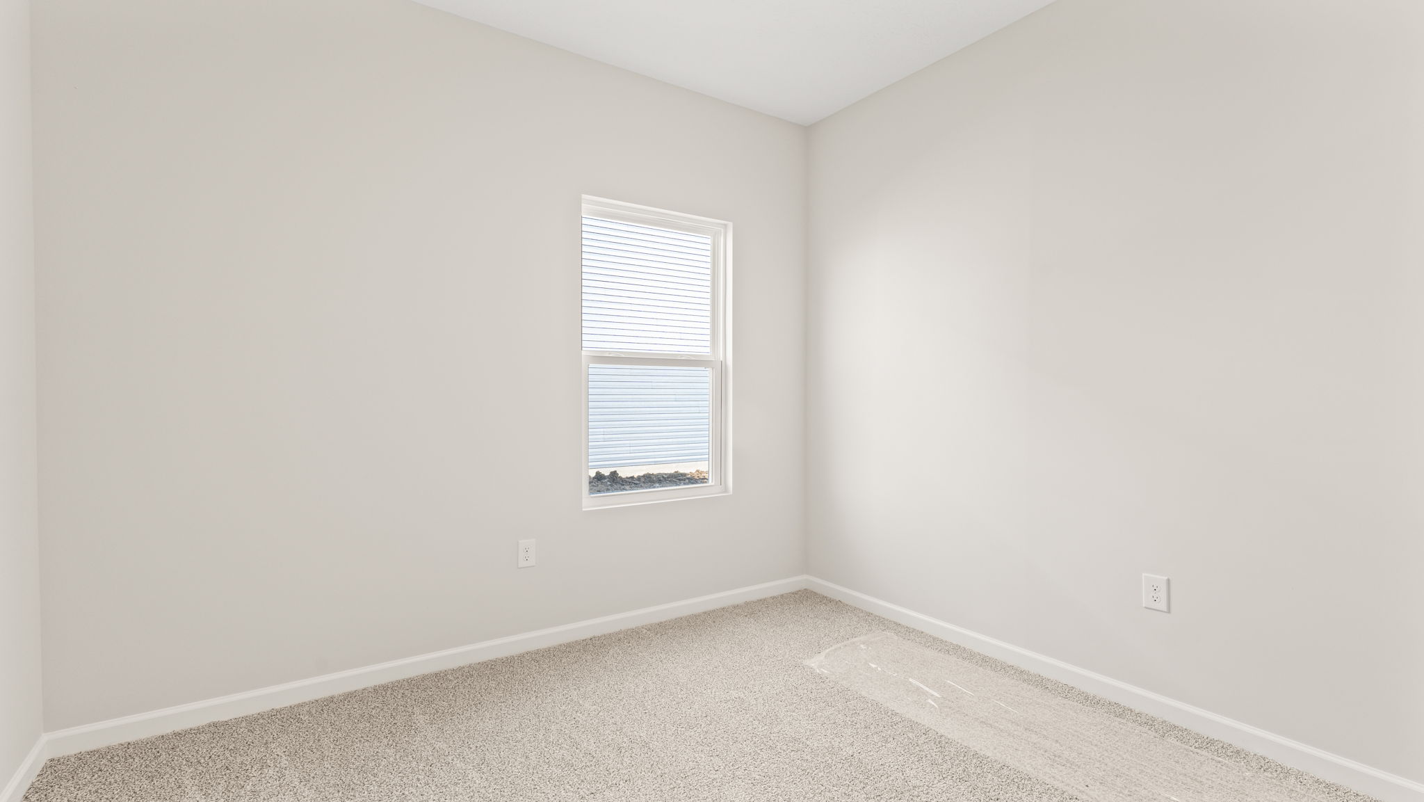 Carpeted bedroom with window