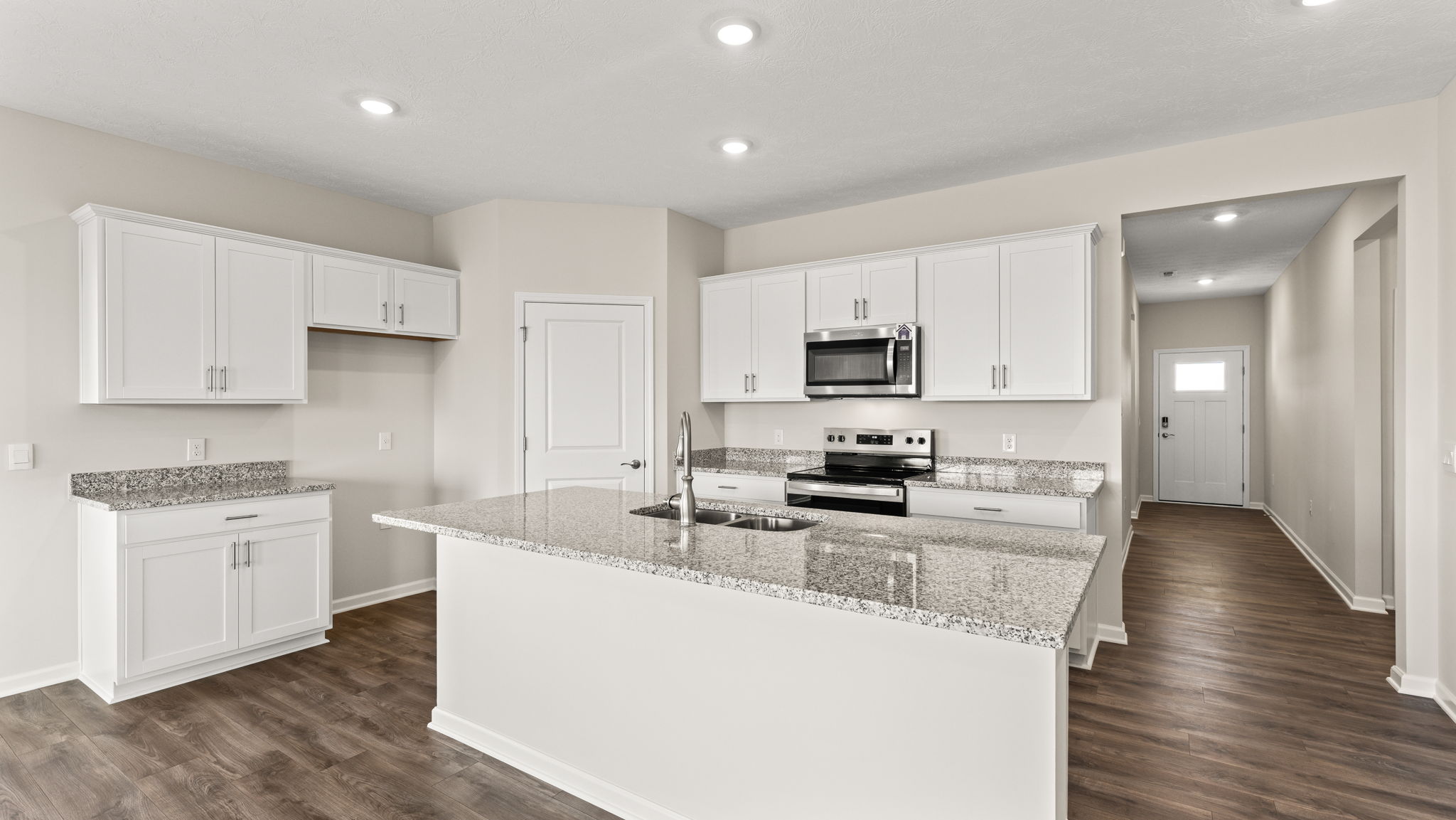 Full kitchen with island, oven range, and cabinetry