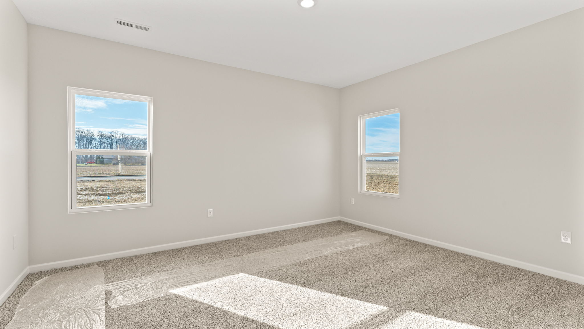 Primary bedroom with two windows