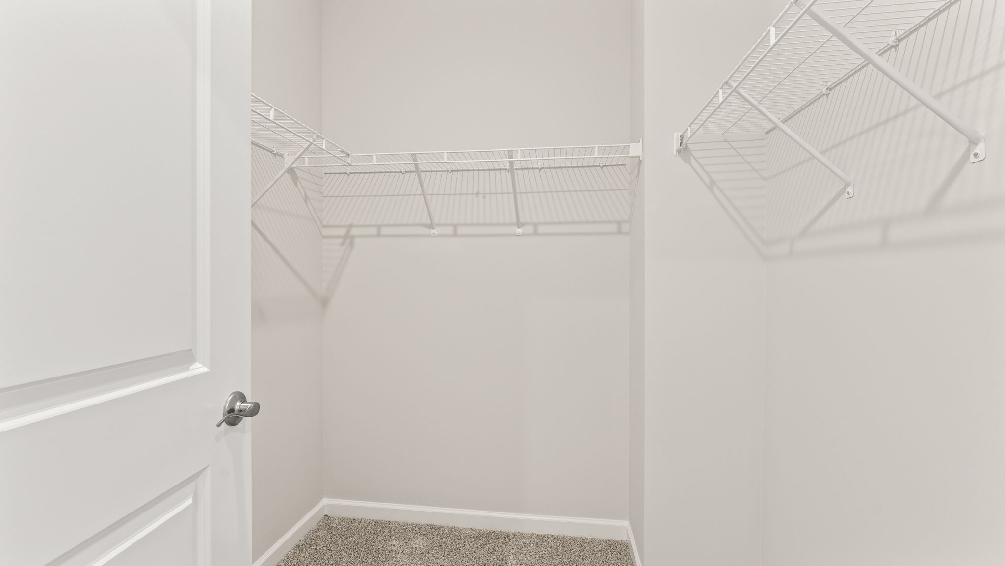 Storage closet with wire rack shelving.