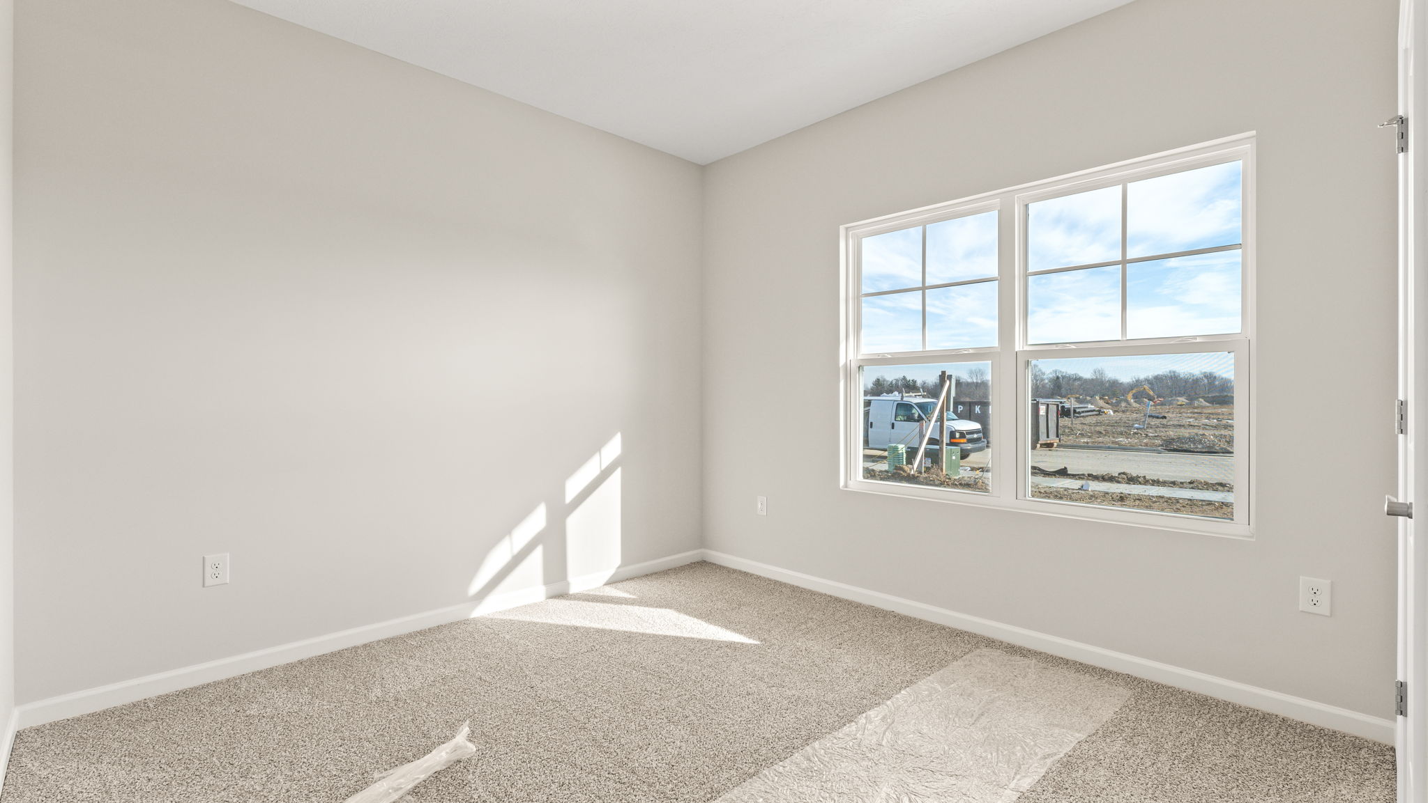 Carpeted bedroom with window