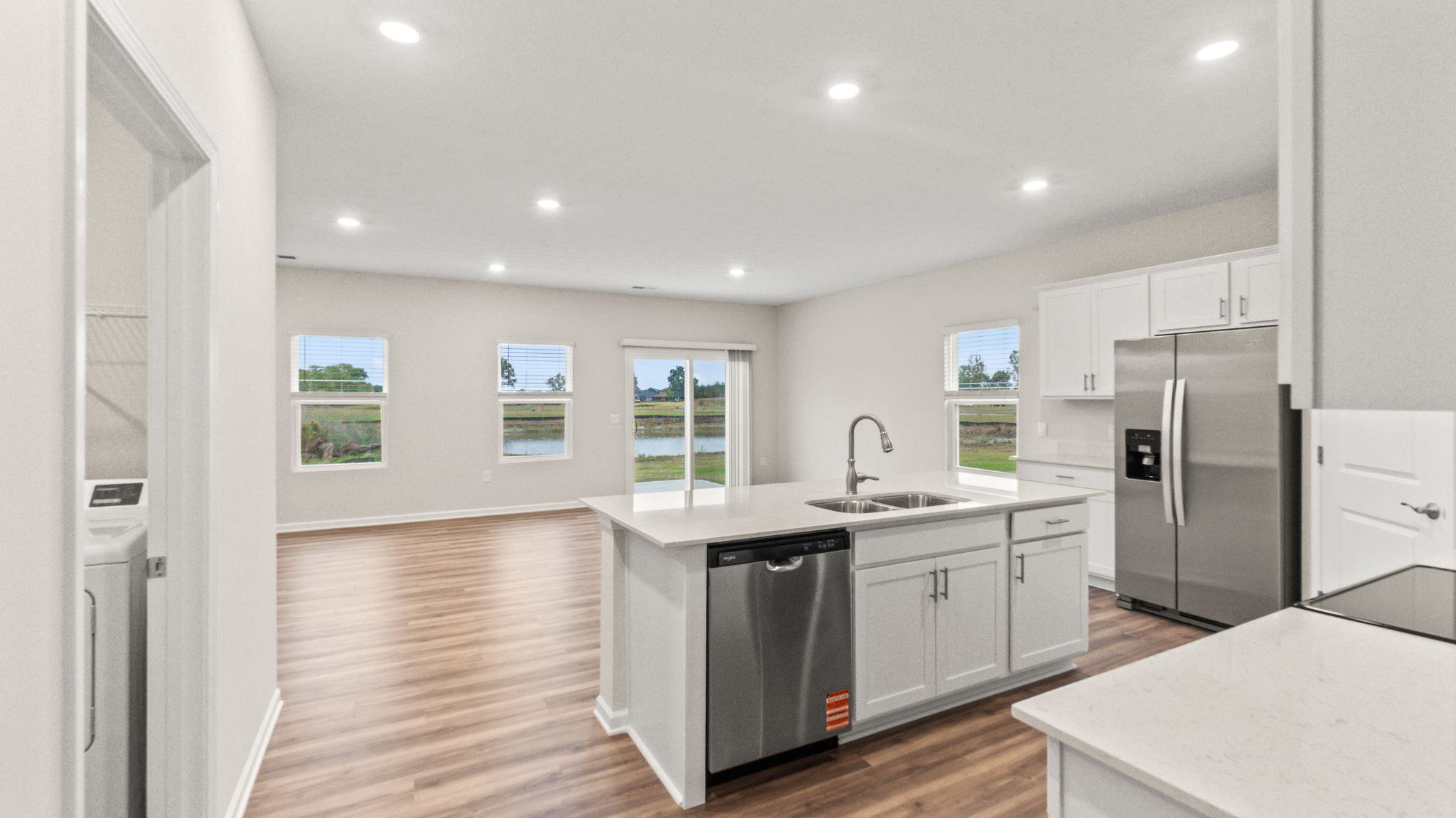 Full kitchen and dining area from behind the kitchen island