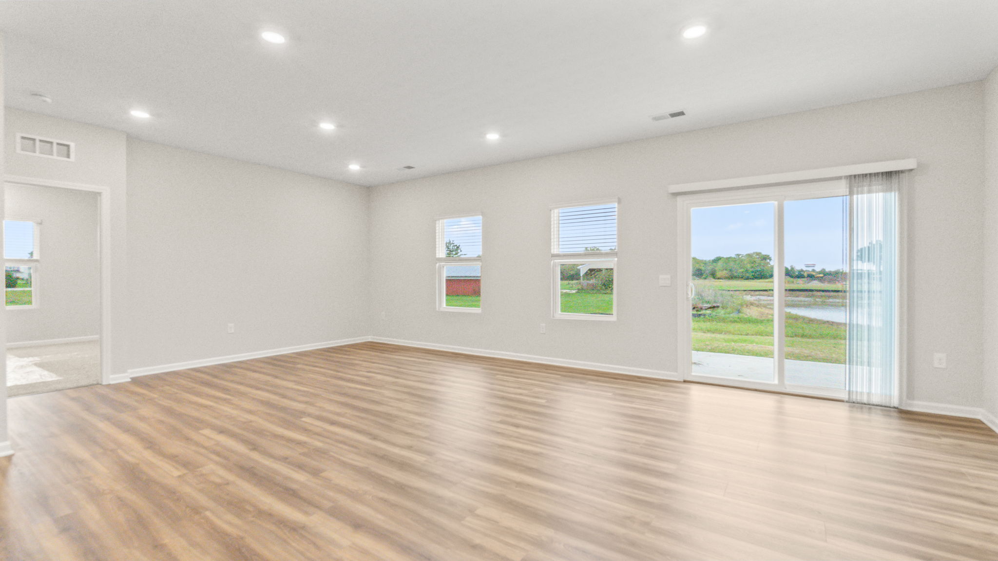 Great area with wood-look flooring, windows, and sliding door to outside
