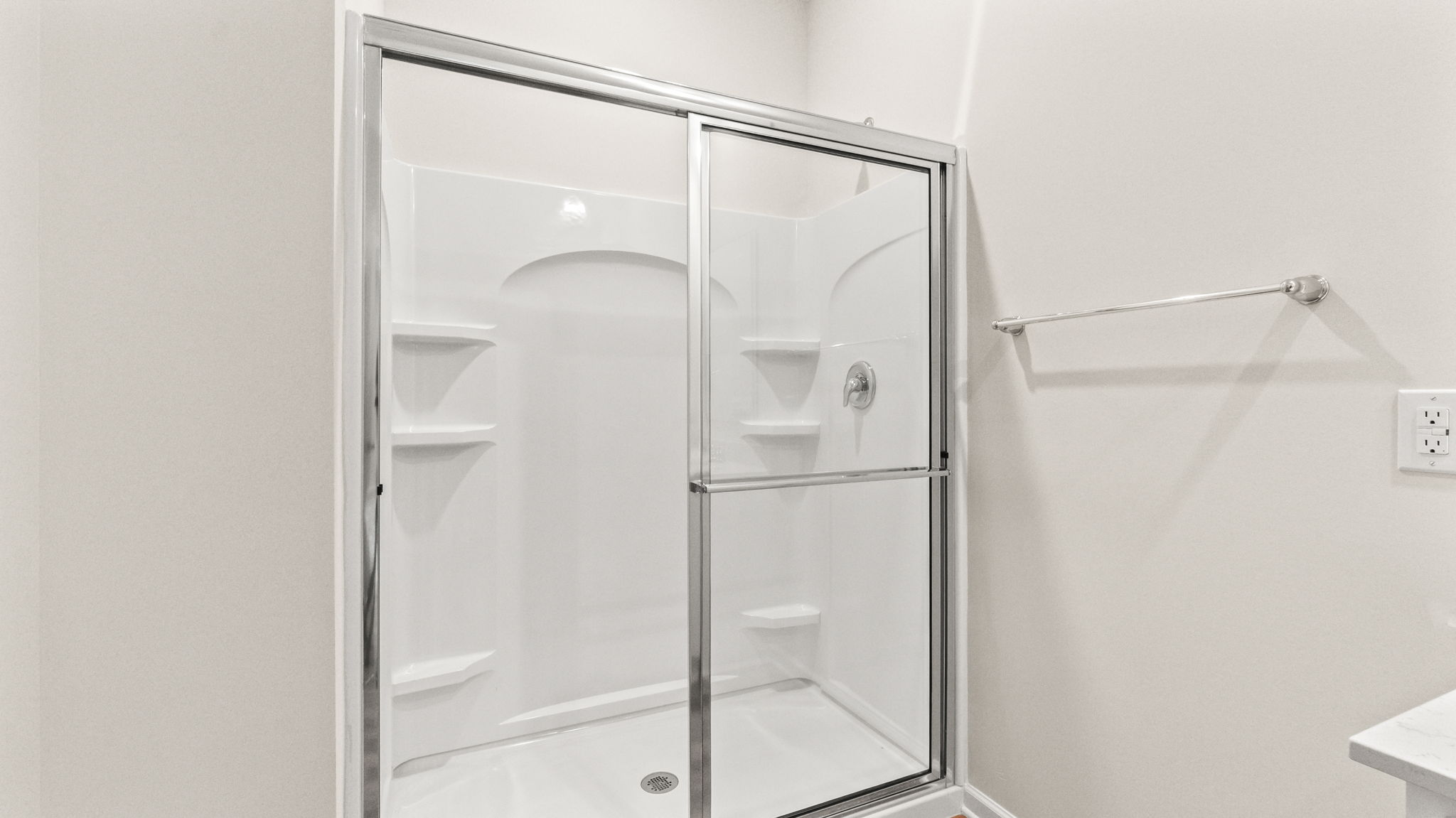 closeup of shower with sliding glass door