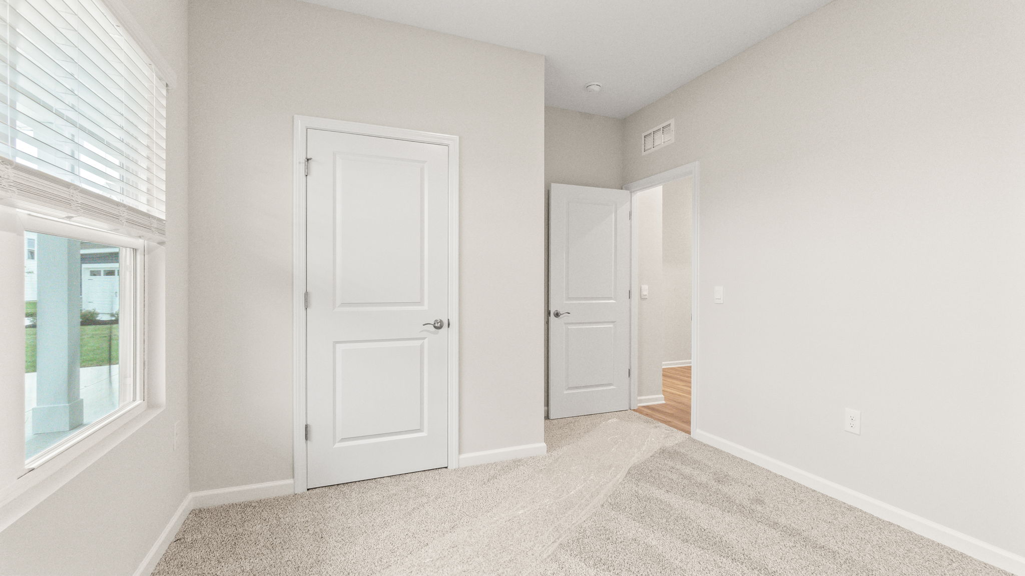carpeted bedroom with view of hallway