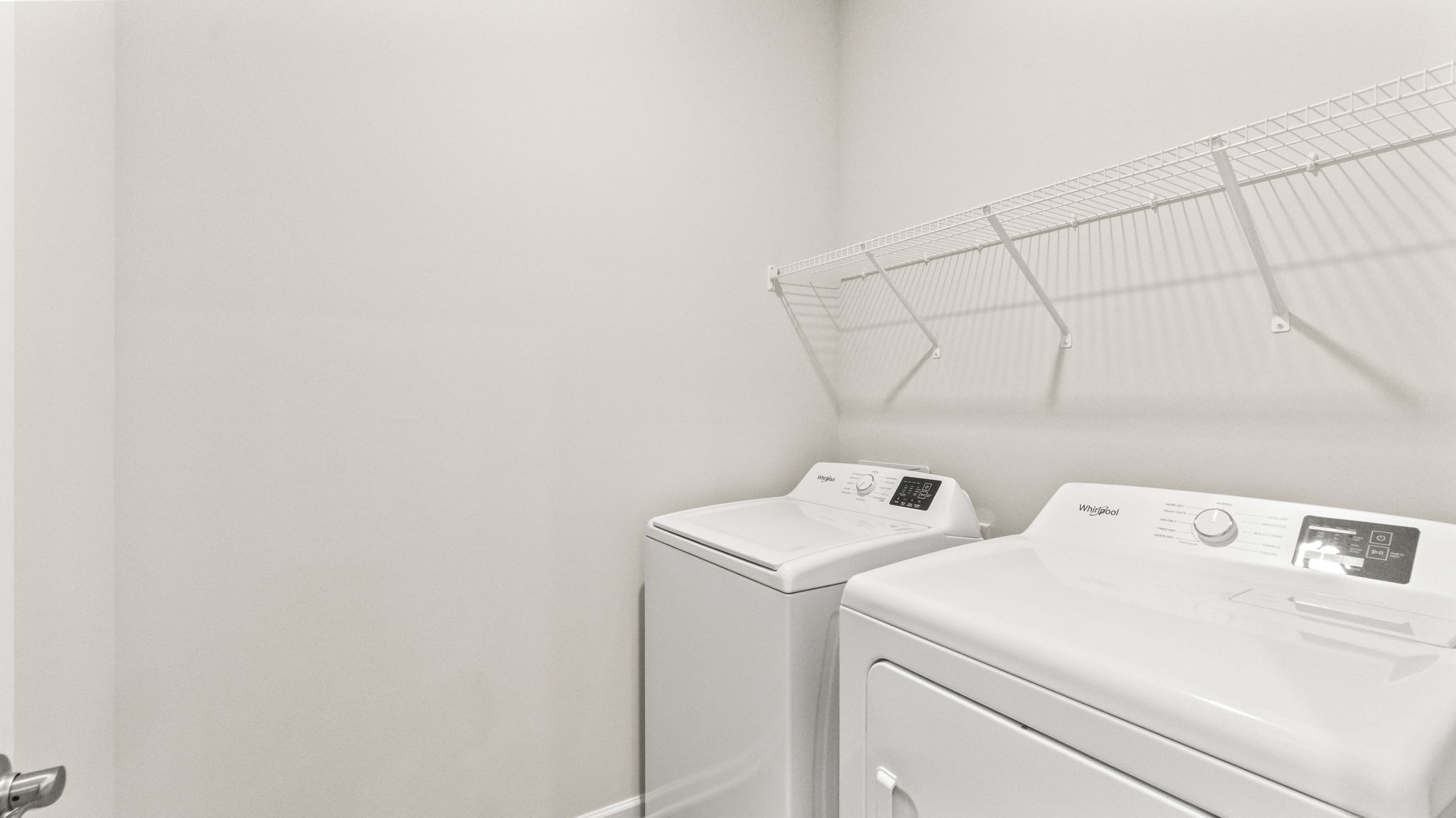 Laundry area with washer, dryer, and wire rack shelving