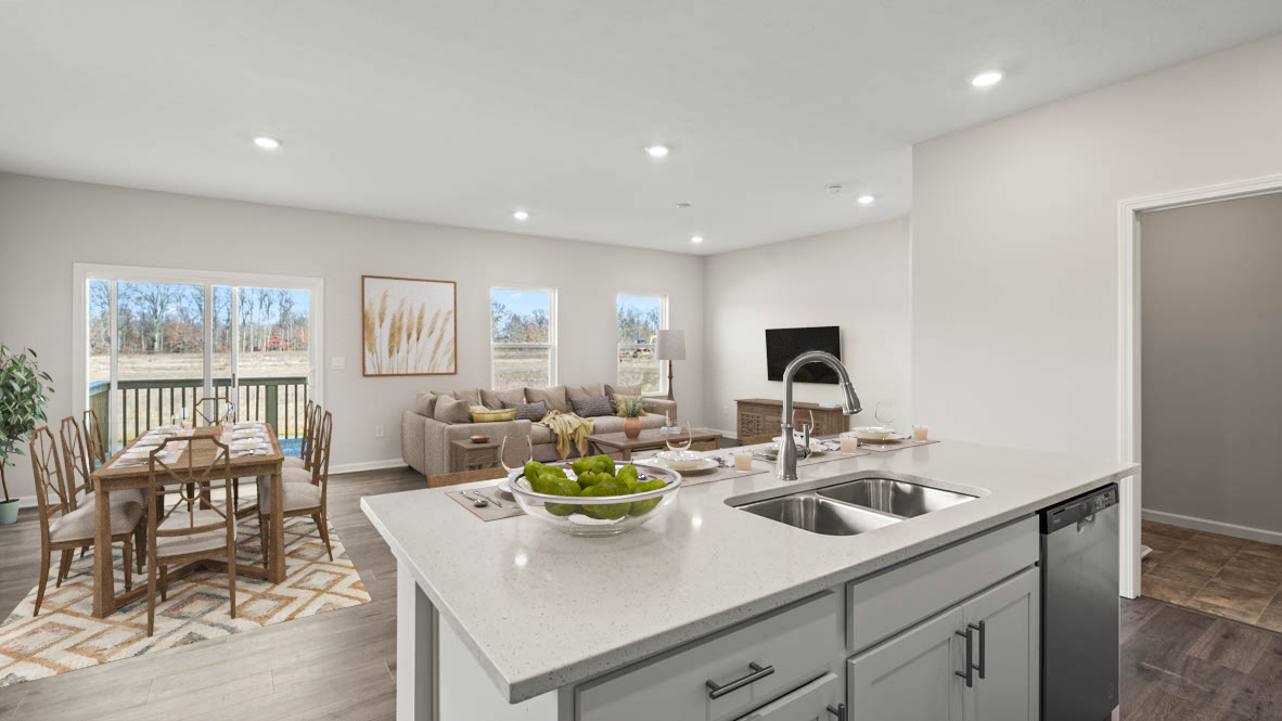 View of kitchen island and great and dining rooms with modern art.