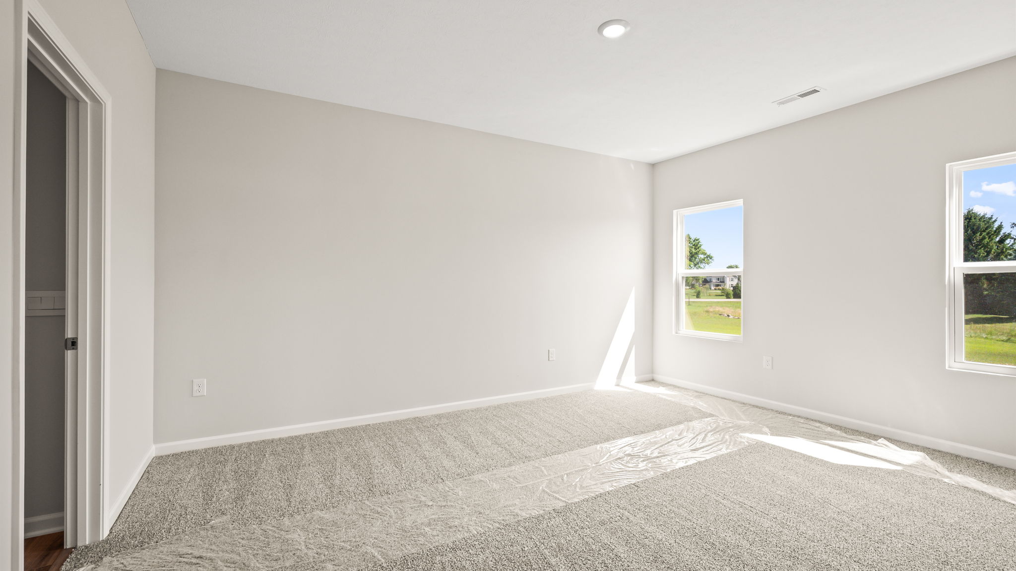 Carpeted primary bedroom