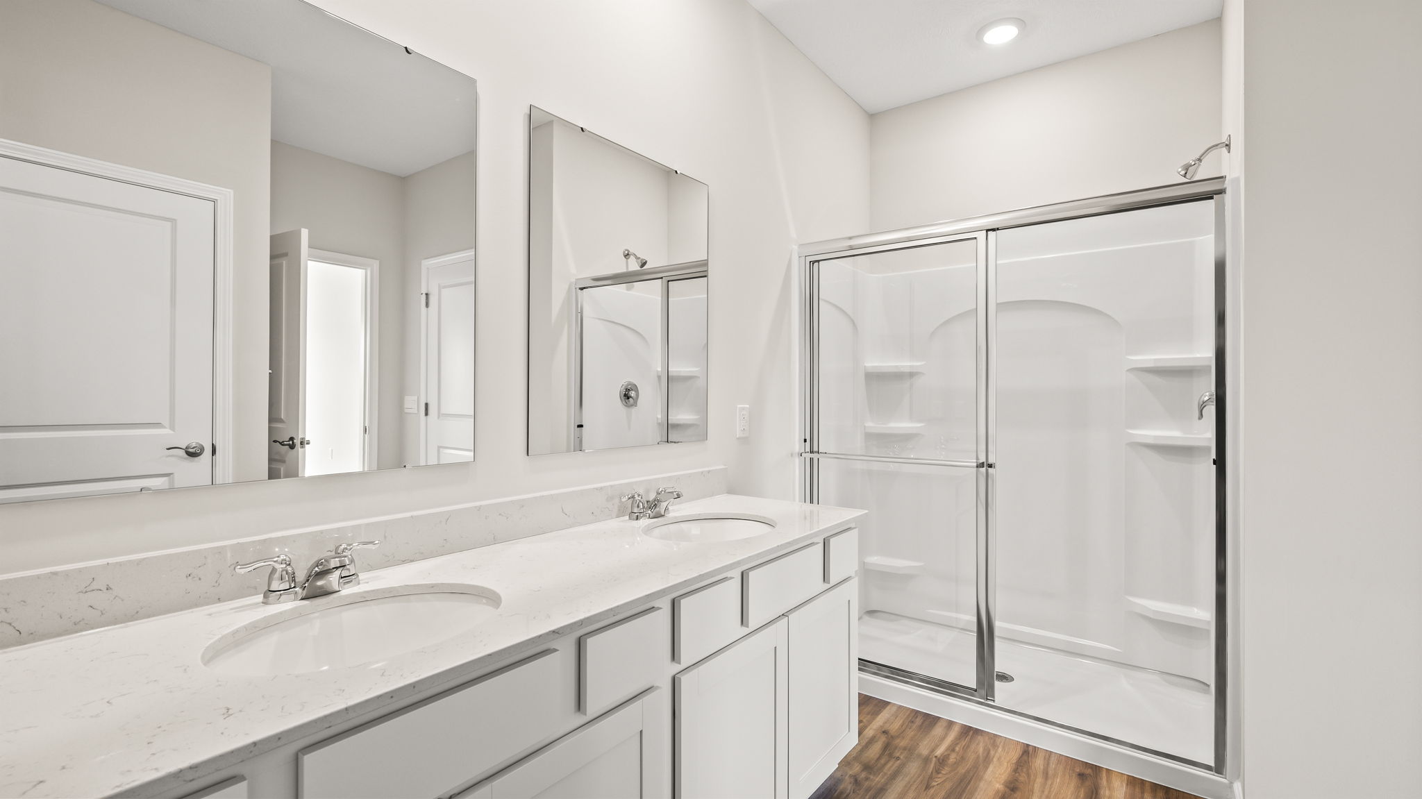 double bowl vanity with mirrors and walk-in shower