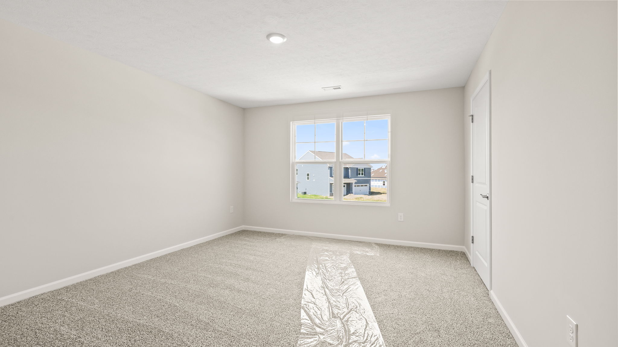 Carpeted bedroom with window
