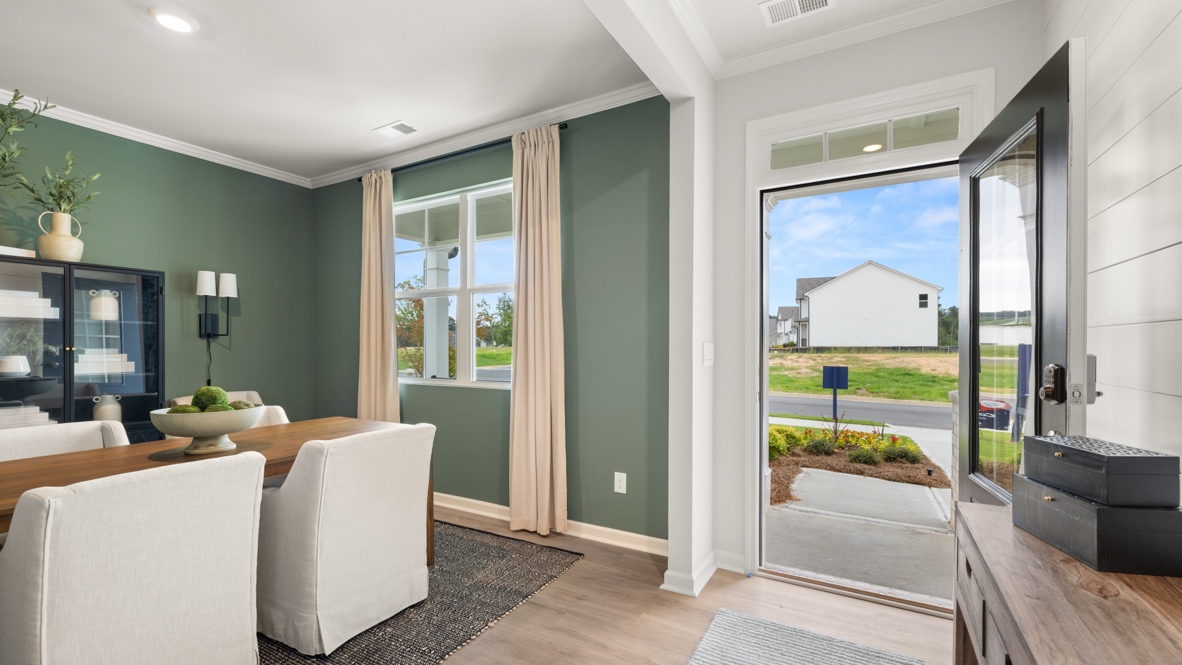 Entrance to the home with table and chairs on the left and outside on the right