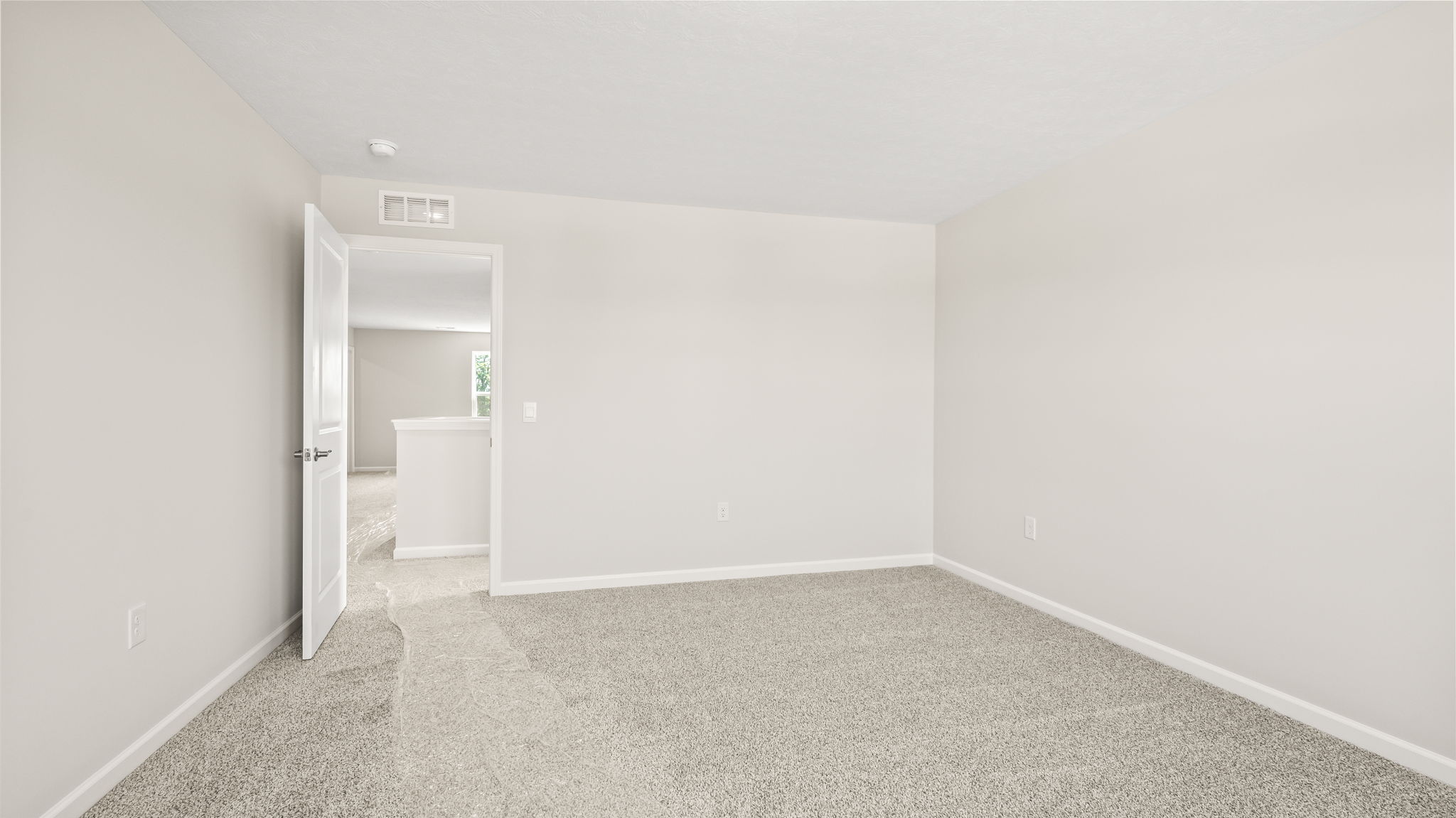 carpeted bedroom with  door to outside