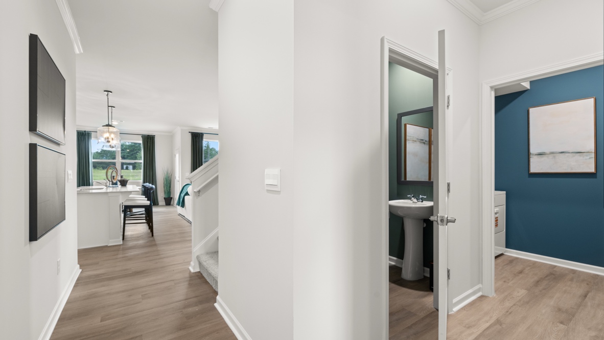 Foyer with view of great room, upstairs, powder room, and laundry room
