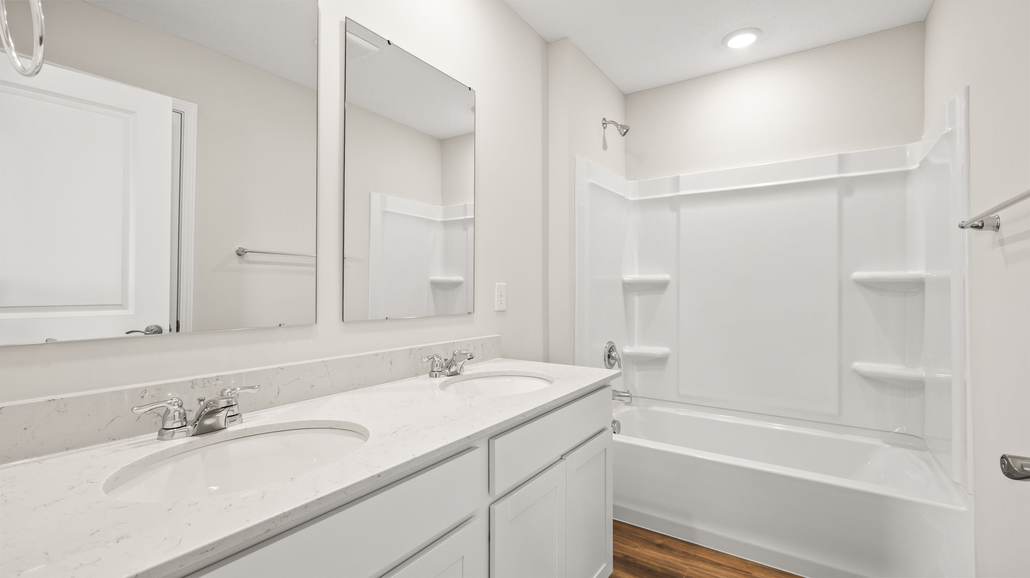 Wide image of bathroom with dual vanity sink