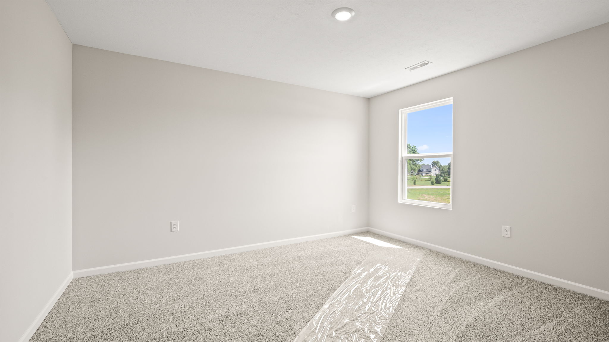 Carpeted bedroom with window