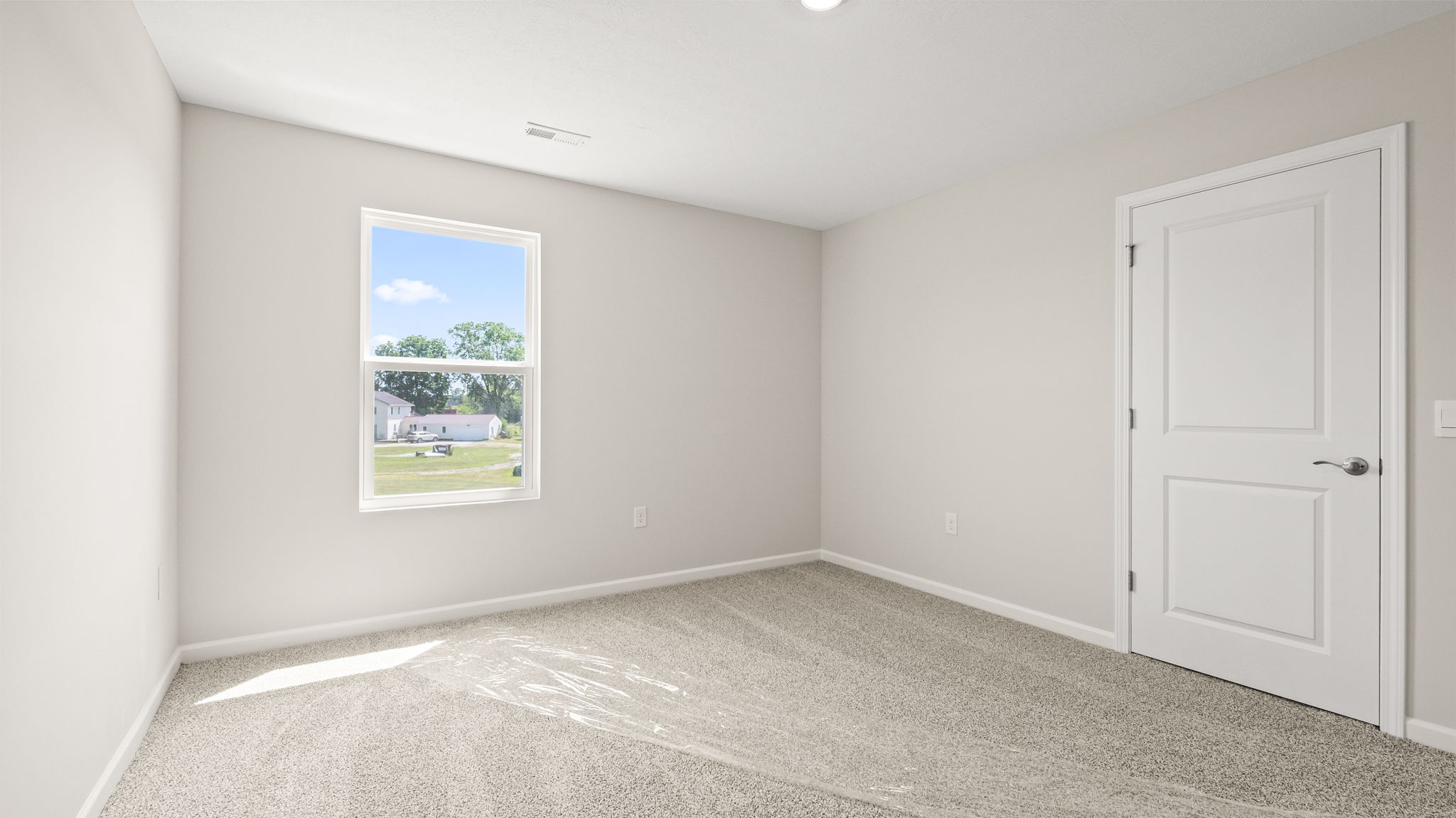 Carpeted bedroom with window and closet door