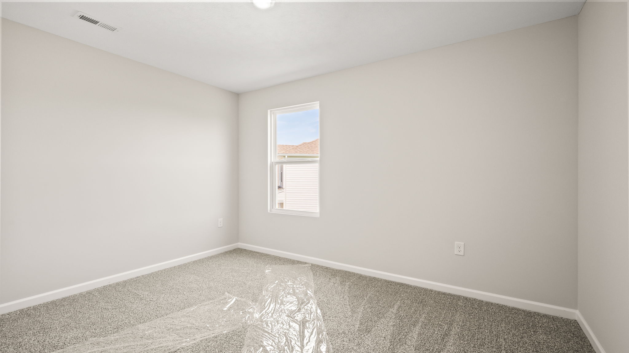 Carpeted bedroom with window