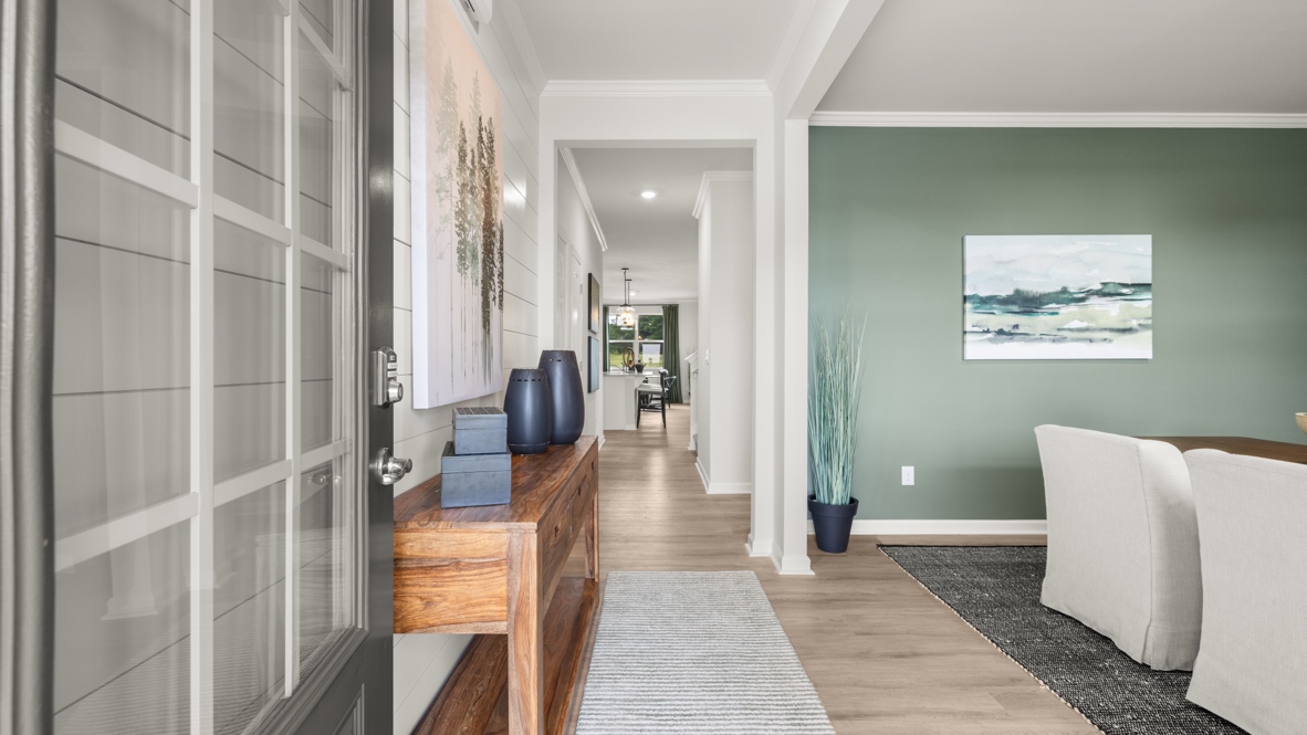 Entrance to the home with door on the left and foyer on the right.