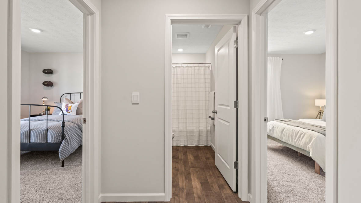 view of both bedrooms and shared bathroom in Harmony.