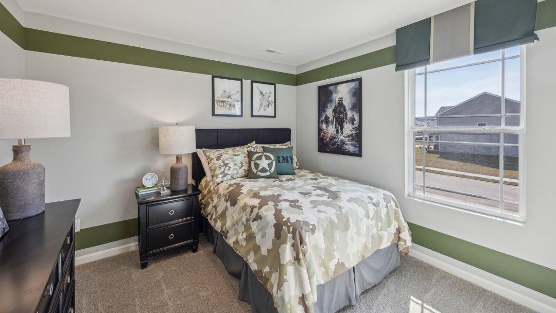 bedroom decorated in military decor, featuring black wooden furniture and a window